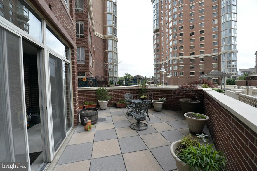 1 of a Kind, 2 BR (or 1 BR & Den), 1 BA unit w/higher ceilings, encl balcony (NOT incl in 988 sqft) & private outdoor patio-perfect for grilling, gardening & relaxing. HUGE kitchen w/numerous cabinets. Upgrades Incl: Marble Foyer, upgraded kit appl, mirrored closets, w/d, etc. 1 Garage & Storage. Enjoy pool,2 gyms, tennis, putt green,24hr security,etc. Blocks to Metro,Movies,shops,restaurants etc.