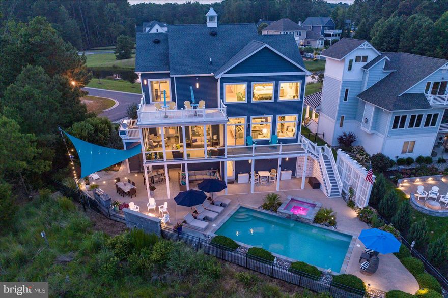 This waterfront 4BR/3.5 bath custom built home in the highly desirable community of Bay Point Plantation is extraordinary.  It encompasses endless water views and was built with the finest materials, custom upgrades and impressive attention to detail.  Every aspect of this home is beautifully oriented to take advantage of views, sunrises and sunsets. The main floor has 10-foot ceilings and expansive water views.  The gourmet chef’s kitchen has water views, custom shaker cabinets, under counter lighting, Subzero refrigerator, six burner stove, other high-end appliances, an oversize walk-in pantry, quartz countertops and a custom walnut center island. The chef in your family is going to enjoy cooking in this unbelievable gourmet kitchen.  The kitchen flows to the dining area which also overlooks the water. There is a screened in deck off the kitchen, perfect for outdoor dining. An open deck at the side with a gas grill for outdoor barbecues which can be enjoyed while watching the sunset night after night.  The spacious family room has water views and overlooks the pool and spa with another deck.  This home has an abundance of natural light and a feeling of serenity. There is a gas fireplace to enjoy during cozy winter nights. The southern exposure brings spectacular winter sunrises into view.  The wet bar with Subzero wine cooler is adjacent to the family room.  The main level also has a beautiful study with built-in storage, half bath and a butler’s pantry designed for entertaining and prepping food with a second dishwasher. On the upper level is the primary bedroom suite with custom closets, lavish primary bath, upgraded tile and heated flooring.  There is a deck off the primary suite for enjoying expansive water views and the natural beauty of the preserve. There is also a laundry room on this level, two additional bedrooms, a full bath and a deck off the third bedroom.  The lower level has a fourth bedroom, full bath, plenty of storage, custom built-in cabinets and another laundry room. There is an elevator which goes from the lower level up to the upper level of the home. There is a two-car oversize garage on the right side of the home and an additional garage on the left side of the home. The outdoor entertaining space in this home is spectacular.  There is a 30x15 saltwater in-ground heated pool with adjacent spa. There are outside Sonos speakers, ceiling fans, a golf cart storage area, custom industrial grade shades and lighting, and an irrigation system.  This home has a resort feel and plenty of outdoor space to suit everyone.  Enjoy the gas fire pit area off the pool in the Fall when a chill begins to take over the night air.  The home comes with a boat slip at the adjacent marina with direct access to the bay you are only minutes away by boat from the inlet and West Ocean City.   Bay Point Plantation is a gated community providing extra peace of mind and a close community feel.  There are only 33 lots with a 142-acre nature preserve with wooded trails and spectacular views of the marsh. This stunning home is offered for sale for $2,399,900.  Please ask for the upgraded features list for a complete list of upgrades.