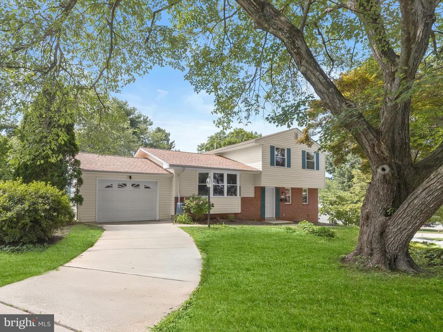 Welcome to this beautifully updated 3-bedroom, 2.5-bath split-level home, perfectly positioned on a generous corner lot in the desirable Springlake community. Thoughtfully designed with comfort and style in mind, this home offers a layout that enhances both privacy and functionality.  Step into the inviting foyer, where crown molding and new luxury vinyl plank flooring set a refined tone. The spacious family room features a stone-surround gas fireplace and a sliding door that opens to an enclosed porch lined with windows and finished with eye-catching herringbone-patterned brick flooring, offering peaceful views of the tree-lined rear yard and storage shed.
Just a few steps up, the kitchen impresses with vaulted ceilings, granite countertops, ceramic tile flooring, a tile backsplash, and brand-new stainless steel appliances. The adjoining dining area showcases rich hardwood floors, a statement light fixture, and convenient access to the garage. The open-concept living room shares the cathedral ceiling and is flooded with natural light from a southeast-facing bay window.
Upstairs, the serene sleeping quarters include a spacious primary suite with crown molding and a fully renovated bath, complete with a glass-enclosed walk-in shower and elegant ceramic tile surround with a built-in niche. Two additional bedrooms and a second beautifully renovated full bath round out this level.
Recent updates throughout the home elevate its style and value, including a new roof, new windows, refinished hardwood floors on the main level, a 200-amp electric panel, updated electrical system, contemporary lighting, and fresh paint in a modern, neutral palette.
With easy access to Loch Raven Reservoir, shopping, dining, and I-83, this move-in ready home offers the perfect blend of comfort, convenience, and timeless appeal.