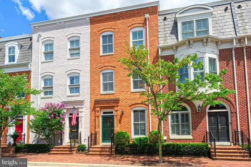 Fabulous Queens Row all-brick townhome with wonderful upgrades including recent stunning kitchen with white cabinetry / stainless steel appliances and a remodeled luxury primary bath with clear-glass shower and sumptuous separate free-standing soaking tub.  Wow, there are even views of the river from the upper two levels!!!  This well-loved home has the amenities sought after in active and fun Old Town.... three bright and open levels, hardwood floors, crown molding, ten-foot and twelve-foot ceilings, two gas fireplaces, built-in cabinetry, large room sizes, a full ensuite bath for each of the three bedrooms, a sunny rear bay window,  transom windows, skylights and even two assigned parking spaces!!!   You and your guests are greeted by a brick walkway and brick front porch that opens to an extended foyer with a wood staircase with classic runner.   The amazing kitchen has tall top-quality cabinetry, quartzite counters, a designer tile backsplash, glass doors, recessed lighting and gas cooking.   Off the kitchen is the breakfast room that has crown molding, 6-inch baseboards and a window overlooking the city activity.   The formal dining room has hardwood floors, a newer chandelier and the old world details in its extensive moldings.  The living room welcomes everyone with a gas fireplace, hardwood floors, built-ins, recessed lighting and a four-section French door with a transom window opening to the slate patio and the fenced rear yard.   The primary suite has a wall of closets plus a walk-in closet.  It has hardwood floors, 12-foot ceilings, the second gas fireplace, recessed lighting and a large bay window receiving the morning sun.  The primary bath has been completely remodeled with newer cabinetry, marble counters, dual sinks, designer lighting, separate tub and shower and floor-to-ceiling rectangular tiles.  How relaxing!!!  The second bedroom has hardwood floors, a double closet and two windows offering afternoon western sun.  It has its own updated bath with ceramic tile and newer lighting.  The sunny bright upper staircase with one of two skylights takes you to the top level and the third bedroom with its own full bath.   Also on this upper level is a terrific office/den area and a family room with a dormer window overlooking the river and the laundry room with extended storage.   There is access to the roof with its amazing Old Town and river views.  The zoned gas furnace and the gas water heater are tucked away on this level.   This gorgeous home is in the middle-of-it-all, but is quiet, and is sophisticated, but comfortable.  It is only one block from Founders Park and the river.   There are extensive dining options nearby that are both formal and relaxing.   Catch the trolley to enjoy all of King Street and Old Town or have an evening of fun on a riverboat.  The walkways and bike trails along the river are seconds away so you will make good use of the community bike room.   Your dream home is now available!!!