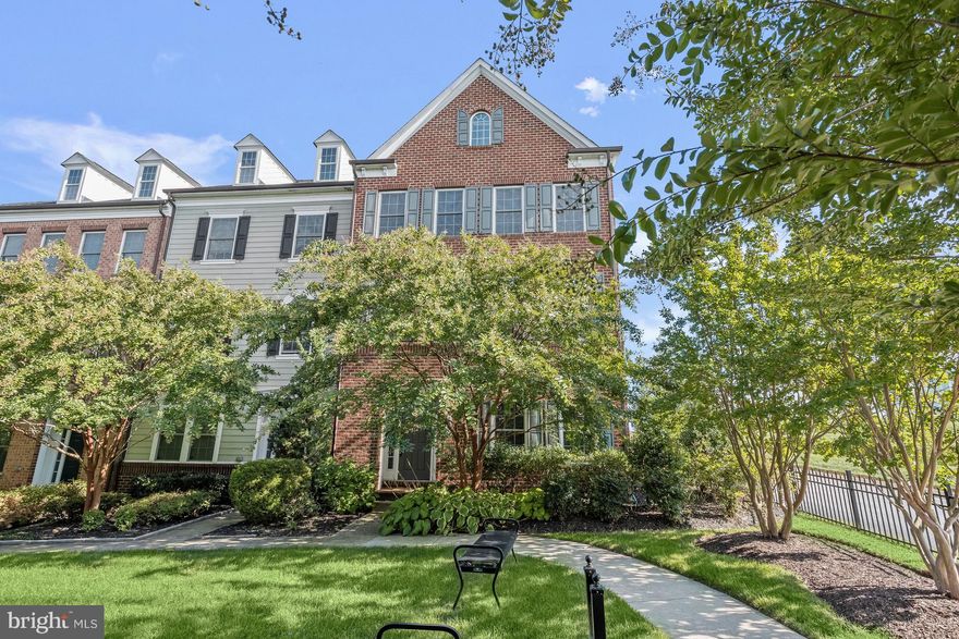 Introducing this stunning end unit brick front townhome located in the desirable Maple Lawn community, offering a perfect blend of style and functionality. Recent stylish upgrades enhance the already high-end features, which include elegant crown molding, a modern neutral color palette, and an open concept floor plan that creates a sense of spaciousness throughout. The heart of the home is a welcoming living and dining room, complete with a dual-sided fireplace that adds warmth and charm. The kitchen is a chef's dream with 42-inch espresso cabinetry, granite counters, stainless steel appliances, a gas cooktop, island, breakfast bar, pantry, and modern pendant lights. The adjacent breakfast room and family room with deck access offer versatile living spaces for entertaining and everyday comfort. Upstairs, the spacious primary bedroom boasts a tray ceiling, sitting area, two walk-in closets, and an en-suite bath featuring a double vanity, soaking tub, and separate shower. Two additional bedrooms, a full bath, and a convenient laundry room complete the upper level. The entry-level recreation room with luxury vinyl plank flooring, a full bath, and a fourth bedroom that can also serve as a home office provides even more functional living spaces. Outside, sip your morning coffee on the deck and enjoy memorable evenings on the patio gathered around the fire pit within the privacy-fenced backyard. With a detached 2-car garage and the added privacy of an end unit facing a common courtyard, this townhome has it all. Enjoy the ease and convenience of having shopping, dining, and entertainment options all within the Maple Lawn community. An array of amenities await your arrival, including an outdoor pool, community center, fitness facility, multiple playgrounds, picnic pavilion, dog park, basketball, tennis, pickleball courts, and so much more! Property Updates: Washer & dryer, deck, patio, luxury vinyl plank, foyer tile, carpeting, interior paint, primary ceiling fan, and kitchen pendants.