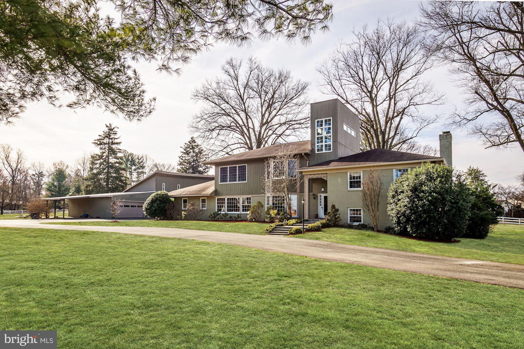 Ideally located in close proximity to Virginia and downtown Washington, this special property, sitting on a 2 acre corner lot, overlooks Congressional Country Club and is across from the historic Hermon Presbyterian Church. The heart of the home is the renovated kitchen with a large center island. There is a breakfast area with a built-in banquette opening to the living room with an antique oak fireplace. The adjacent dining room is perfect for entertaining, with wood paneling and two sets of glass sliding doors leading to the pool and backyard. A family room, with a vaulted wood ceiling, would make a perfect first floor bedroom with an adjacent full bathroom.The upper level has three bedrooms (one being the original master bedroom) and two full bathrooms. In 2007, the owners added a third level with a master suite, and a second large bedroom also with en-suite bathroom. The two story hall with windows is a dramatic architectural feature. The lower level has a recreation room with a corner brick fireplace and a full bathroom. The home"s updates include a newer roof, a new above-ground oil tank (installed in 2016) and an updated HVAC system. There is a kidney shaped pool for outdoor enjoyment. A bonus is a wonderful two-story structure with 4950 sq. ft., heated floors and 6 hinged doors for easy access that can be used in a variety of ways. CAR COLLECTORS TAKE NOTE ROOM FOR 16 CARS!