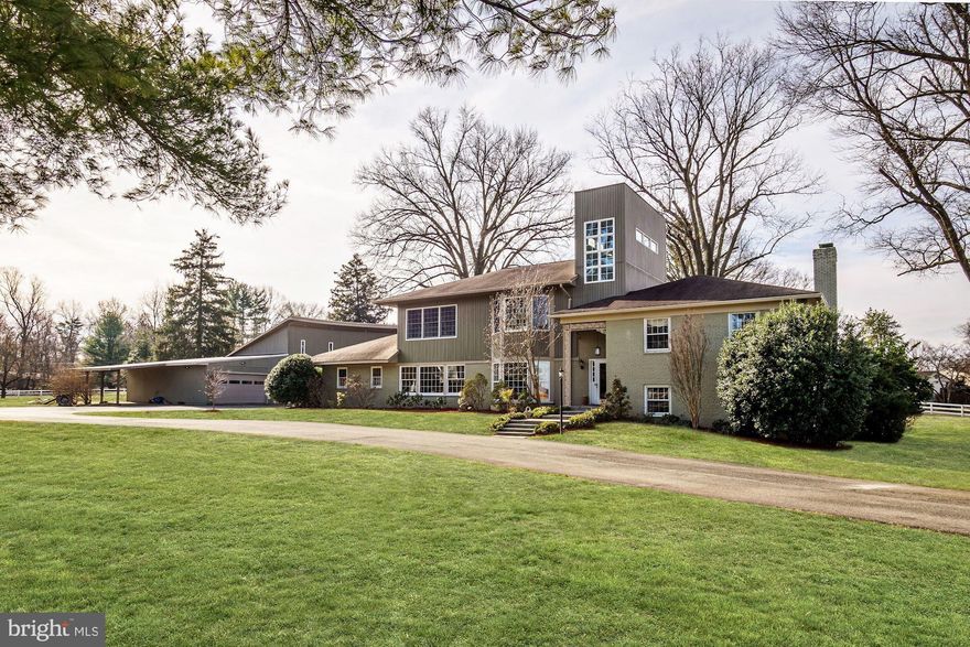 Ideally located in close proximity to Virginia and downtown Washington, this special property, sitting on a 2 acre corner lot, overlooks Congressional Country Club and is across from the historic Hermon Presbyterian Church. The  heart of the home  is the renovated kitchen with a large center island. There is a breakfast area with a built-in banquette opening to the living room with an antique oak fireplace. The adjacent dining room is perfect for entertaining, with wood paneling and two sets of glass sliding doors leading to the pool and backyard. A family room, with a vaulted wood ceiling, would make a perfect first floor bedroom with an adjacent full bathroom.The upper level has three bedrooms (one being the original master bedroom) and two full bathrooms. In 2007, the owners added a third level with a master suite, and a second large bedroom also with en-suite bathroom. The two story hall with windows is a dramatic architectural feature. The lower level has a recreation room with a corner brick fireplace and a full bathroom. The home"s updates include a newer roof, a new above-ground oil tank (installed in 2016) and an updated HVAC system. There is a kidney shaped pool for outdoor enjoyment. A bonus is a wonderful two-story structure with 4950 sq. ft.,  heated floors and 6 hinged doors for easy access that can be used in a variety of ways.  CAR COLLECTORS TAKE NOTE ROOM FOR 16 CARS!