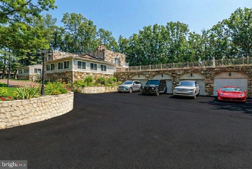 ***PROPERTY HIGHLIGHTS*** Elevator * Main-Floor Primary Suite * Second Floor Primary Suite * 4 Fireplaces *5-Ensuite Bedrooms *2 Bedroom + 1 Bathroom Basement Apartment *Outdoor Kitchen with Pool and Outdoor Shower * 3-Car Garage

In a market largely defined by production-built homes, this exceptional custom residence stands apart—thoughtfully designed for those who seek originality, scale, and a truly bespoke living experience. A spectacular tailored home that was created for those who value architectural individuality, craftsmanship, and distinction.

Set on over two fully fenced acres at the end of a quiet cul-de-sac, 11701 Locust Grove Court offers a rare combination of privacy, scale, and lifestyle-driven amenities in Bowie. This thoughtfully designed residence delivers the space and flexibility today’s buyers seek—both indoors and out—while remaining conveniently close to commuter routes, shopping, and local conveniences.

Inside, expansive, light-filled living areas are designed for both everyday comfort and effortless entertaining. The home features well-proportioned rooms, a natural flow between living and dining spaces, and classic finishes that provide a timeless backdrop for personalization. The chef's kitchen anchors the main level, offering generous cabinetry, a waterfall island with a prep sink, an upscale range with a pot filler above, ample counter space, and a seamless connection to adjacent gathering areas, with a butler's pantry.

The private quarters include a spacious primary suite with an en-suite bath and substantial closet space, complemented by additional bedrooms suitable for guests, home offices, or multigenerational living. A flexible lower level offers additional rooms, including 2 bedrooms, a full bathroom, a kitchen, and a private entrance. A space fit for recreation, media, fitness, or extended living—tailored to suit your lifestyle needs.

Outdoors, the property truly distinguishes itself with a gated entrance. The fully fenced two-plus acres create a secure and serene setting ideal for entertaining, play, or relaxation. An elevated rooftop patio with an outdoor kitchen offers a striking space for al fresco dining, entertaining, and sunset views—an exceptional feature rarely found in the area. There is even a pool with an outdoor shower and a playground steps away.

Combining privacy, land, and distinctive outdoor amenities, 11701 Locust Grove Court presents a unique opportunity to enjoy refined suburban living with resort-style elements. Qualified Buyers are welcome to tour.  To facilitate showings, a pre-approval letter or proof of funds for cash buyers is kindly requested.

*Ceiling chandeliers/pendants are virtually staged.