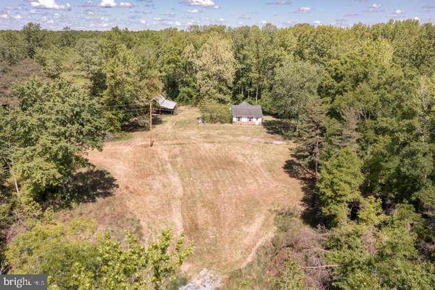 Welcome to this  beautiful10 acres of luscious land that's waiting for you to turn in to your dream home.  The land has so much potential, let your imagination run wild.  The home is in "as-is"  condition, it is not livable, do not enter.