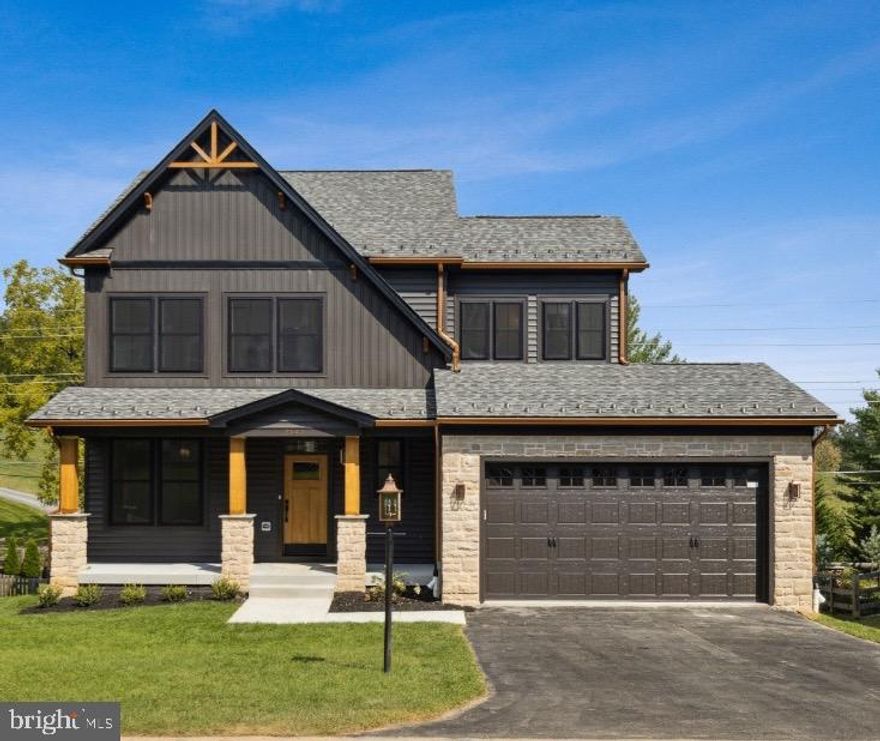 HOME TO BE BUILT. Build this beautiful, custom home, modify to suit your needs or build something completely different on gorgeous 5 acre lot in Boonsboro with stunning views. This home offers beautiful curb appeal with a nod to modern design elements. The dark slate exterior of the home is accentuated by copper-colored gutters, black windows, and cedar-covered wood grain exterior accents. Through the front door, the first floor includes a flex room with sliding barn doors, a powder room, and an open floor plan that includes a gourmet kitchen with upgraded cabinets, stainless steel appliances, quartz or granite counter tops and a huge island. Open plan to family room with vaulted ceilings and with wood burning or gas fireplace. Upstairs, the owners’ bedroom features a luxury ensuite bath with a tiled shower, double vanity, and walk-in closet. Three additional bedrooms, a full bath, and laundry complete the second floor living space. Superior construction with 2 x 6 walls, 35 year architectural shingles, electric car charger, tray ceiling, crown molding, extra trim detail, and much more. Pick your own finishes or modify plan to suite. You could even build a completely different model if you choose. Pictures are representative of model / finishes of home in this price range. Optional deck and screened porch an additional 25k.