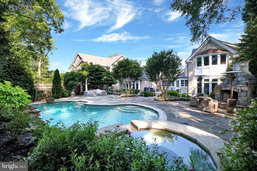 Classic charm meets contemporary living in this stunning Bethesda residence, perfectly situated in one of the area’s most coveted neighborhoods near the Metro and downtown. This four-bedroom, three-and-a-half-bath home offers a seamless blend of traditional architecture and modern luxury, designed for both everyday comfort and exceptional entertaining.

From the moment you arrive, you’re welcomed by a European-inspired exterior featuring stucco and stone finishes, a gas lantern, and a brand-new paver driveway leading to a garage and ample off-street parking. Inside, the warmth of a gas brick fireplace in the foyer and views of the resort-style backyard set an inviting tone. The main level includes a formal dining room, a sun-drenched chef’s kitchen with a granite island, Sub-Zero refrigerator, Viking gas range, and a breakfast nook overlooking the lush front yard. Anchoring the home is a vaulted‑ceiling family room with a stone wood‑burning fireplace, custom built-ins, and a concealed Sonance sound system paired with Sonos controls—perfect for cozy nights or movie marathons.

The main floor also hosts three spacious bedrooms, a stylish powder room and full bath, a home office with serene pool views, and a dedicated laundry room with an additional fridge. Downstairs, the finished lower level provides flexible space for a second living area, gym, or guest suite, complete with a custom bar and full bath. Upstairs, the private primary suite feels like a luxury retreat, featuring soaring ceilings, a seating area, extensive closet storage, and a spa‑inspired bath with a jetted tub, oversized walk‑in shower, and dual vanities.

Step outside to your own private oasis—an entertainer’s dream with a heated pool, integrated hot tub, cascading waterfall, and multiple lounging areas. Mature landscaping, including crepe myrtles and Norwegian evergreens wrapped in twinkling lights, frames the space, while a pergola draped in wisteria adds a touch of magic. An outdoor fireplace and Sonos‑controlled sound system complete the scene, making this backyard as ideal for peaceful evenings as it is for lively gatherings.

Just steps from Downtown Bethesda’s vibrant core, this home offers effortless access to an array of shops, restaurants, cafes, and entertainment along Bethesda Row. Nearby grocery choices include Harris Teeter, Trader Joe’s, and Whole Foods Market—bringing everyday convenience right to your doorstep . This exceptional home offers a rare opportunity to enjoy timeless style, modern convenience, and unparalleled outdoor living—all in the heart of Bethesda. Co-Listed by Tiffany Cloud @ Meredith Fine Properties.