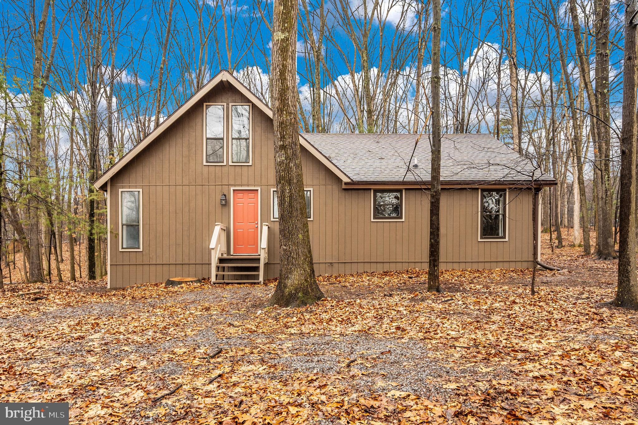 Another quality, complete renovation project by South County Ventures, LLC. Beautiful 3 bedroom (true 3rd bedroom)/2 full bath modified Elmwood model with large addition (added/permitted + inspected in 2001). Situated on a .89 acre corner lot in The Woods Resort. Renovations include all new HVAC, 4 year old roof, kitchen cabinets, quartz kitchen counters with peninsula, stainless steel appliance package, updated baths including tub/shower/vanity/floor, new lighting package, LVP flooring, carpet, custom interior/exterior paint, plumbing fixtures, all textured ceilings removed and finished with drywall. Beautiful main level living area includes a soaring window wall + wood burning fireplace insert and addition with vaulted ceiling + exposed beams. Home offers a newly insulated crawl space for storage. Enjoy the view of the wooded yard from the large, full length back deck and screened porch. Walking distance to the Walden pool, sports center + Sleepy Creek Spa & Salon. ALL RENOVATIONS completed by licensed contractors. Class A or Class B membership available until March 1, 2024 with an initiation fee of $3,150.00. Private club amenities are not owned or operated by the HOA nor are their dues included in the HOA fees. Private club amenities include: golf (greens fees), driving range, chipping green, putting green, indoor sports center (racquetball, indoor pool, gym, aerobics room, laundry facilities, sauna, steam room, whirlpool, volleyball, indoor & outdoor tennis, indoor & outdoor basketball, shuffleboard, pickleball), 2 outdoor pools, clubhouse, club room, baseball field, playground + fishing ponds. Other onsite amenities include: The Clubhouse Grille & Pub + the Sleepy Creek Spa & Salon.