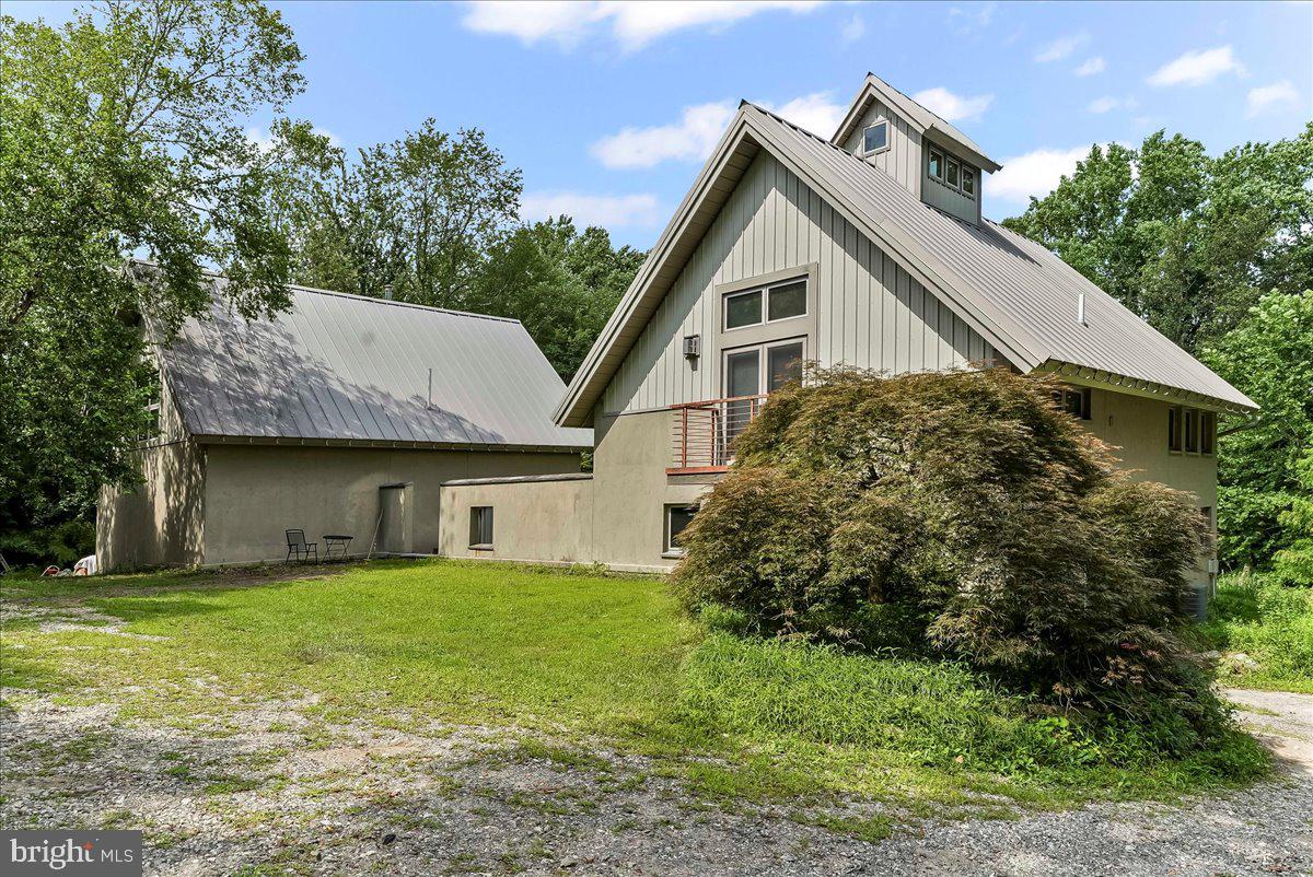 Alert: Painters, potters, sculptors, weavers, woodworkers: a home and studio to inspire your creativity. Your new home is located at the end of a private lane, nestled in the woods overlooking a serene valley. Unique custom build in 2007 features a well thought out plan with radiant heat floors, a 3 story great room crowned with a cupola, wood stove, gas fireplace, high end appliances and amazing views from the courtyard and patio. The 1568 sq ft residence structure is complemented by the 1568 sq ft studio structure that affords first and second level spaces well suited to whatever activities you desire. Schedule your tour today!