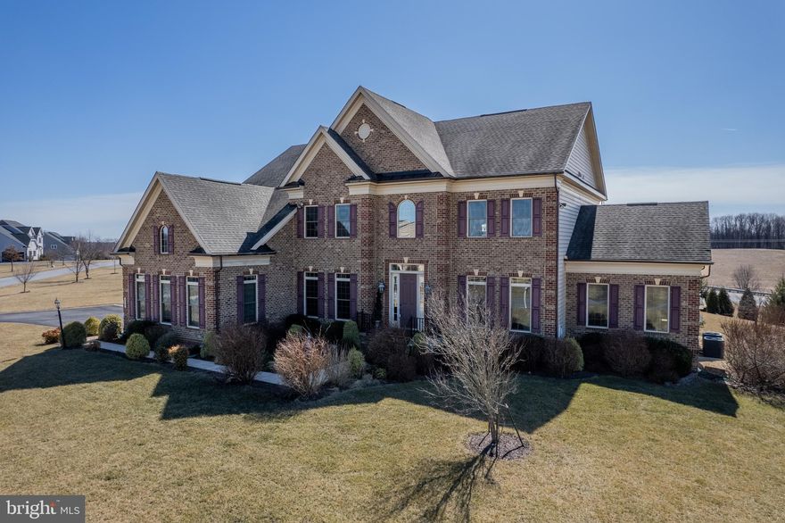 Welcome to 710 Placidville Way, an exquisite residence nestled in the Pooledale Farms neighborhood of Eldersburg, MD. One of NV Homes prestigious models, the Clifton Park II, offers an impressive living space that totals almost 9,000 square feet, with 5,898 square feet above grade, all situated on a lush 1.5-acre corner lot.

As you enter, you are greeted by an elegant open foyer with pristine wood floors and a captivating upstairs balcony hallway that overlooks the two-story living area, adorned with a refined coffered ceiling. The luxury kitchen is a culinary dream, featuring two islands, a gas cooktop with a wall-mounted pot spigot, double ovens, and a wine fridge, ensuring every meal is prepared with ease and sophistication.

Adjoining the living area is a grand conservatory sunroom, enveloped in windows that invite natural light to dance throughout the space, creating an ambiance of serenity and grace. From the kitchen, step outside to a custom deck that spans the length of the home, leading to a beautifully designed outdoor patio complete with a kitchen and a covered pergola—ideal for entertaining and enjoying the tranquil surroundings.

The fully finished luxury lower level is a haven for relaxation and entertainment, boasting a theater room, a wet bar, and an additional bedroom with a private full bath. This level epitomizes comfort and convenience, offering a private retreat within the home.

Additional features include a backyard fruit orchard, a full-house installed vacuum system, comprehensive security with cameras, a modern solar system that is completely owned, and professional outdoor lighting and oversized shed.

This newly built residence, less than ten years old and freshly painted, exudes elegance and modernity, offering a lifestyle of unparalleled luxury and convenience. Don't miss the opportunity to make this exceptional property your own.