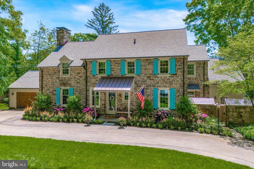 Welcome to 315 Caversham Road! Character and charm abound throughout this lovingly maintained and recently updated center hall stone Colonial, which is ideally located on a private Main Line cul-de-sac and within walking distance to the Bryn Mawr train station, restaurants, shopping, post office, weekend farmer's market, area private schools, Bryn Mawr College, Ashbridge Park and much more! Nestled on a beautifully landscaped 1/2 acre, with specimen trees, stone-walled vegetable garden, and mature landscaping, the property provides both privacy and convenience in a scenic Lower Merion neighborhood. Enter into the foyer with coat closet that leads to both a large office with French doors and custom built-ins and the spacious sun-filled dining room. The dining room opens to the large living room which has a wood burning fireplace and access to a lovely sunroom which overlooks a flagstone patio and the spacious, flat backyard. The sunroom is a year-round space thanks to heaters and custom interchangeable windows and screens. The sunroom also provides access to the attached oversized two-car garage with additional storage space above. The kitchen, which is open to the dining room, was recently updated with all new stainless steel appliances and boasts a breakfast nook. Adjoining the kitchen is a sizable mudroom with separate exit, containing laundry, built-in cubbies, wet-bar, and desk area. There is also a charming, enclosed flagstone courtyard off the mudroom as an additional option for al fresco dining near a separate grilling area. In addition to the first floor living space, the basement, which has been completely renovated by the current owner, includes a walk-out au pair suite with full bath, large playroom/additional family room, bespoke wine cellar and exercise room. The second floor boasts 4 bedrooms, including a lovely primary suite and a primary bathroom with double vanity, soaking tub, and custom frameless glass shower. One of the bedrooms is currently used as an antechamber to the master, with custom built-ins serving as additional closet space and a sitting room/second office. Two additional updated bathrooms round out the second floor.  Coupling yesteryear's charm with today's amenities in a coveted location, this distinctive home is truly a 'must see' for the discerning buyer.