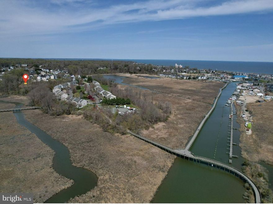 DESIGN & BUILD ! This gorgeous home site in Chesapeake Beach is below the cul-de-sac elevation, and away from other homes. Commute easily to/from the DC Metro area. Your daily water view will include rich marsh textures and wildlife scenes, the serpentine shape of Paw Paw Gut as it flows to Fishing Creek.  A home project here might be a good candidate for a passive solar home energy program. The existing plan is for a 2760 square foot house with integrated 24 x 24 garage.  MUST VERIFY: Impact fees have been paid, the construction entrance is in. Public water tap is at the driveway entrance, and gravity-fed sewer will be tapped in the line below the building site. Tap fees to be verified.  The Chesapeake Beach Railway trail is in view from the site, and you can access the trail entrance nearby. Great south-facing view of the water and trail walkway. Kayak on Paw Paw Gut to Fishing Creek, watch bald eagles, hawks, ducks, osprey, geese and more. NOTE: THIS PROPERTY IS NOT IN THE HOME OWNER’S ASSOCIATION!