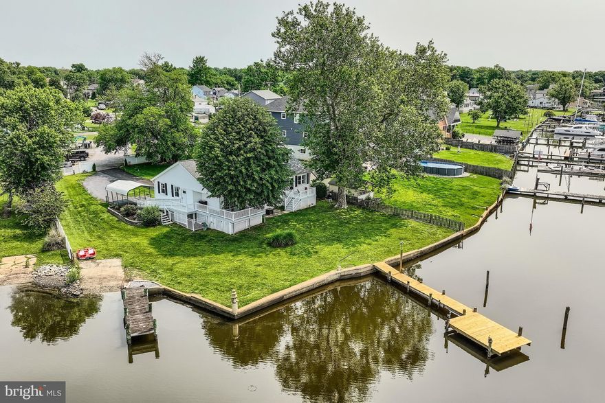 Breathtaking Waterfront Retreat on Jones Creek! Welcome to your private oasis in the heart of Sparrows Point, a rare opportunity to own a spectacularly renovated single-family home offering approximately 140 feet of panoramic waterfrontage on .33 acres of pristine shoreline. This stunning property features two piers, a private boat ramp, and breathtaking views from nearly every room, creating the ultimate waterfront lifestyle experience. Step inside to a light-filled foyer with immediate water views, a convenient half bath, and laundry room. The open-concept main level invites you into a gourmet chef’s kitchen complete with granite countertops, under-cabinet lighting, stainless steel appliances, cooktop, built-in oven and microwave, crisp white cabinetry and stunning backsplash. The large kitchen bar offers plenty of seating, and the adjacent dining area flows effortlessly into a spacious living room with a cozy sitting nook, all designed to showcase stunning water views. From this space, step out onto the first of two expansive decks, where you can soak in the waterfront breeze and take in truly unforgettable views. The upper level features two generously sized bedrooms and a beautifully updated custom tiled full bath. What makes this property truly unique is its flexible layout, ideal for large families or multigenerational living. Off the main living area, a separate wing includes a massive family/rec room/dining area with vaulted ceilings and sliding glass doors that lead to a second waterfront deck, perfect for entertaining. Here, you'll also find a luxurious full bath with a jetted tub and custom-tiled walk-in shower, and an exceptionally renovated second kitchen, never used, all brand new, featuring vaulted ceilings, granite countertops, white cabinetry, stainless steel appliances, custom backsplash, a spacious bedroom with walk-in closet, all with water views and a private upper-level bedroom complete the space with brand new egress skylight window, flooding the space with natural light! This wing offers its own separate entrance with a ramp, making it ideal for an in-law suite, guest quarters, or private family living. Throughout the home, you’ll find all-new luxury vinyl plank flooring, blending durability with high-end design. Additional highlights include an attached garage, a spacious driveway, a covered carport, and a partially fenced yard. The recently waterproofed basement offers an oversized storage area for all your needs. This home boasts two dual HVAC systems for efficient climate control, a 6-year-young roof,  a new main pier with fresh decking, new pylons and electrical hookups. A second pier, just five years new, complements the property, both ready to accommodate your boat, jet skis, or simply enjoy peaceful waterfront living. And when you’re ready to explore, hop on the paddle boat for a magical ride along the creek, just minutes from the brand-new Sparrows Point Park. Enjoy a full day of activities, from playgrounds and scenic walking paths to storytime and music & movement for your little ones, as well as activity rooms, a community center, athletic fields, and so much more, all just minutes from your dock. Whether you're entertaining on the dual decks, launching a boat from your own ramp, or simply unwinding by the water, this exceptional home delivers a lifestyle few can match. A true waterfront gem-inside and out. From boating adventures to sunset dinners on the dual decks, or simply unwinding with the gentle sounds of the water, this exceptional property invites you to live the waterfront lifestyle to the fullest. Truly a rare find, where comfort, beauty, and location meet. So, what are you waiting for? Come take a tour, fall in love, and make this enchanting waterfront retreat the next chapter in your story!!!
