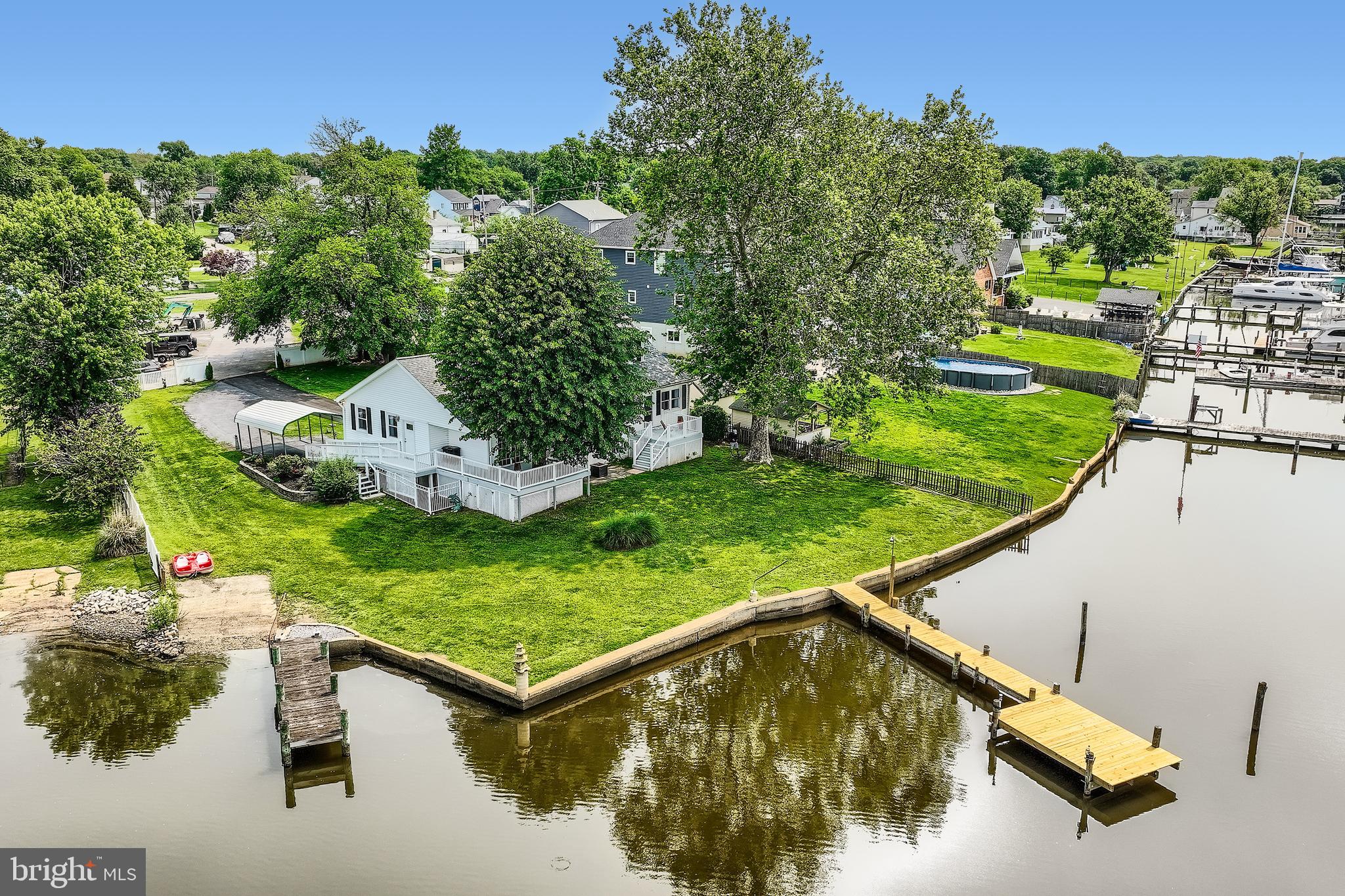 ***OPEN HOUSE: THURSDAY, JULY 10, 2025, 5:00 PM - 6:00 PM. STOP BY AND SEE WHAT MAKES THIS WATERFRONT HOME TRULY ONE OF A KIND! Breathtaking Waterfront Retreat on Jones Creek! Welcome to your private oasis in the heart of Sparrows Point, a rare opportunity to own a spectacularly renovated single-family home offering approximately 140 feet of panoramic waterfrontage on .33 acres of pristine shoreline. This stunning property features two piers, a private boat ramp, and breathtaking views from nearly every room, creating the ultimate waterfront lifestyle experience. Step inside to a light-filled foyer with immediate water views, a convenient half bath, and laundry room. The open-concept main level invites you into a gourmet chef’s kitchen complete with granite countertops, under-cabinet lighting, stainless steel appliances, cooktop, built-in oven and microwave, crisp white cabinetry and stunning backsplash. The large kitchen bar offers plenty of seating, and the adjacent dining area flows effortlessly into a spacious living room with a cozy sitting nook, all designed to showcase stunning water views. From this space, step out onto the first of two expansive decks, where you can soak in the waterfront breeze and take in truly unforgettable views. The upper level features two generously sized bedrooms and a beautifully updated custom tiled full bath. What makes this property truly unique is its flexible layout, ideal for large families or multigenerational living. Off the main living area, a separate wing includes a massive family/rec room/dining area with vaulted ceilings and sliding glass doors that lead to a second waterfront deck, perfect for entertaining. Here, you'll also find a luxurious full bath with a jetted tub and custom-tiled walk-in shower, and an exceptionally renovated second kitchen, never used, all brand new, featuring vaulted ceilings, granite countertops, white cabinetry, stainless steel appliances, custom backsplash, a spacious bedroom with walk-in closet, all with water views and a private upper-level bedroom complete the space with brand new egress skylight window, flooding the space with natural light! This wing offers its own separate entrance with a ramp, making it ideal for an in-law suite, guest quarters, or private family living. Throughout the home, you’ll find all-new luxury vinyl plank flooring, blending durability with high-end design. Additional highlights include an attached garage, a spacious driveway, a covered carport, and a partially fenced yard. The recently waterproofed basement offers an oversized storage area for all your needs. This home boasts two dual HVAC systems for efficient climate control, a 6-year-young roof, a new main pier with fresh decking, new pylons and electrical hookups. A second pier, just five years new, complements the property, both ready to accommodate your boat, jet skis, or simply enjoy peaceful waterfront living. And when you’re ready to explore, hop on the paddle boat for a magical ride along the creek, just minutes from the brand-new Sparrows Point Park. Enjoy a full day of activities, from playgrounds and scenic walking paths to storytime and music & movement for your little ones, as well as activity rooms, a community center, athletic fields, and so much more, all just minutes from your dock. Whether you're entertaining on the dual decks, launching a boat from your own ramp, or simply unwinding by the water, this exceptional home delivers a lifestyle few can match. A true waterfront gem-inside and out. From boating adventures to sunset dinners on the dual decks, or simply unwinding with the gentle sounds of the water, this exceptional property invites you to live the waterfront lifestyle to the fullest. Truly a rare find, where comfort, beauty, and location meet. So, what are you waiting for? Come take a tour, fall in love, and make this enchanting waterfront retreat the next chapter in your story!!!