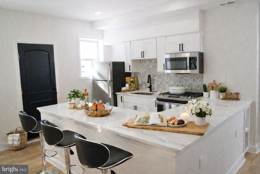 Coming Soon... Welcome to this beautifully updated 4-bedroom, 3-bath home offering a bright, open floor plan and modern finishes throughout. The main level features wide-plank flooring, recessed lighting, and a seamless flow from the living area into the dining space and kitchen—perfect for both everyday living and entertaining.
The kitchen is a true centerpiece, showcasing a large quartz island with seating, sleek white cabinetry, stainless steel appliances, and ample counter and storage space. The open layout allows for easy connection between the kitchen and living areas, creating a spacious and inviting atmosphere.
The lower level offers a versatile flex space ideal for a family room, home office, gym, or guest suite, complete with a full bath and excellent storage options. Additional highlights include an inviting front porch and a large rear parking pad providing convenient off-street parking.

This home combines style, functionality, and flexibility in a layout designed to meet a variety of lifestyle needs. Schedule your private tour today.