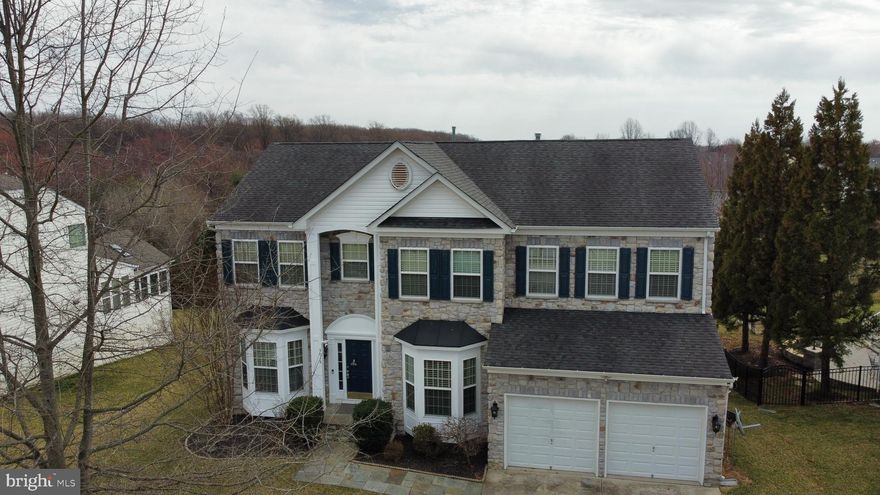 Nestled on a serene street within the highly sought-after Cider Mill community. Stunning stone front home offers a wealth of living space and abundant high-end upgrades. As you step inside, you will find custom finishes throughout, gourmet kitchen that is sure to impress even the most discerning chefs. It boasts exotic granite countertops, custom wood cabinetry, top-of-the-line stainless steel appliances and 2 wall ovens, custom backsplash, oversized sink, huge pantry, cherry hardwood floors seamlessly flow into the living, dining, and powder rooms. The two-story family room feature decorative windows, ceiling fan, and a gas fireplace with mantel, creating a warm and inviting atmosphere. The main level also includes a formal dining room, living room and a powder room with a sleek pedestal sink and custom designer wall paper. Ascend the staircase to the upper level, where four bedrooms and two full baths await. The light-filled primary suite boasts a ceiling with lighted fan, spacious walk-in closet, and en suite bathroom. The primary bath showcases two sink with vanities with storage, a glass-enclosed shower and soaking tub. Along the hallway are three additional bedrooms with neutral carpeting and a full bath with a vanity and standing-shower. The walkout lower level of the home features an expansive theatre room, all with beautiful plush carpet and recessed lighting and an additional large space to entertain a large crowd. An additional full bath and plenty of storage complete the lower level, which walks out to the very private backyard surrounded by beautiful views. The deck off the kitchen is perfect for outdoor dining and family entertainment. The coveted community of Cider Mill offers walking and biking trails and a beautiful community pond.