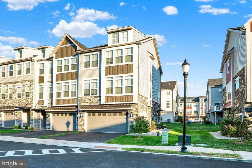 Welcome to The Fields at Constitution Square, centrally located in Perkasie Borough.  This beautiful end unit with a two car garage is rarely offered.  Step inside and you’ll find a bright, sunny, and thoughtfully designed layout that flows effortlessly from room to room. The home features a flexible floor plan that works perfectly for modern living.  The lower level offers a functional flex space perfect for an office, second family room or bedroom with double closets, custom blinds for the sliding door to the custom paver patio for additional  entertaining space.  You will also find a large foyer with walk in closet, a half bath and access to your two car garage. The main living space is filled with natural light, walls of windows and an open floor plan that allows you to be connected to each room.  The luxurious kitchen was well thought out showcasing upgraded stainless steel appliances, custom pendent lighting, recessed lighting, oversized center island with quartz counter-tops, custom Silgranite sink, custom tile back splash, 42 inch custom cabinetry in two fabulous colors, custom window and door treatments and a large walk in pantry.  Open to the kitchen is the formal dining room.  A second outdoor living space is just off the kitchen with a maintenance free Trek deck and lighting built into the railings.  The family room is expansive in size with walls of windows, custom window treatments, closet space, recessed lighting and additionally on this level is a half-bath. Climb the staircase to the upper level with upgraded iron spindles, two secondary bedrooms that share an oversized hall bath with tile flooring and shower/tub combination.   Both bedrooms are generous in size with ample closet space, ceiling fans, neutral coloring and a  dramatic two story vaulted ceiling in one of the bedrooms.  The primary suite offers a large space with large walk-in closet, neutral color carpets, ceiling fan and an  en suite with dual vanity, glass-enclosed tiled shower, tile flooring and linen closet.  The exterior of the home is handsome with black metal roofs, vertical siding, stone and mature landscaping beds.  Across the street from the home you will find the walking and biking trails.  Walking distance to Pickelball courts, but far enough away that you don't hear it, Perkiomen Creek, Parks and all of the locals favorite restaurants, bars and shops. The Borough of Perkasie established their own electric grid back in February of 1900 and to this day still has its own municipal electric utility, known as the Perkasie Borough Electric Department. This beautiful home is commuter friendly with access to Route 309, Pa turnpike, Montgomery County, Philadelphia and the Lehigh Valley.   Make your appointment today!