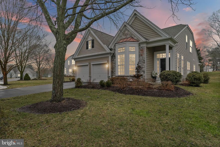 This is the one that you have been waiting for! Located in Chester County's premier 55+ Gold Star community, Traditions at Longwood, this meticulously maintained home is close to Longwood Gardens, Downtown Kennett Square, Chadds Ford, Glen Mills, Greenville, Wilmington, Newark, Philadelphia, Philadelphia Airport, Baltimore, the Brandywine River & Museum, Whole Foods, Wegmans, The Fresh Market, Trader Joe's, numerous retail stores, restaurants, nature parks, trails, PA Wine Trail & vineyards, birding, golf courses, horseback riding and so much more. Within the community, you can enjoy the community garden, pools, tennis, pickleball, walking trails, etc. This particular home is located in the desirable PHASE 1 of this community and occupies a PREMIUM LOT along the quiet inner perimeter of the community; one that affords serene privacy and beautiful views of trees from the outdoor living space. This is the EXPANDED  MAYFIELD model with the extra sunroom which is the largest square footage model constructed here ; between its premium size and premium location in the community, this home is truly a rare opportunity. From the time you pull up to the home, to the time you complete your tour, you will be impressed with the immaculate condition of the property, the lovely hardscaping, the wonderful molding and architectural details throughout, and the upgraded fixtures and finishes. The formal living room is located just off the main entry and it is generously sized and boasts a barrel ceiling. The formal Dining Room is just beyond and it has a stunning, upgraded chandelier and lovely wainscoting and moldings plus a dry bar between it and the kitchen. The kitchen is fully open to the family room, a beautiful light filled window, a gorgeous eat around center island, stainless steel appliances, two closets (pantry and other) plenty of eat-in space and direct access to the garage. The family room just beyond has  a marble, natural gas fueled fireplace and is open to the beautiful sun room space that has an exit to the outdoor, hardscaped patio space. The primary bedroom and bathroom are conveniently located in the back of the home with a gorgeous picture window that frames the stunning views behind the home perfectly. The primary bedroom has tray ceilings, a spacious sitting area, a large walk-in closet plus a wonderful en-suite bathroom with a large tub, separate stall shower, separate toilet room, and a long double sink vanity. The main floor also has the laundry room and powder room located near the kitchen and dining rooms. The second and third bedrooms and second full bath as well as a second floor family room/office/den are located on the upper level. In addition to the main HVAC system, owners installed a mini-split unit on the top level. This home has upgraded finishes such as hardwood  and tile floors throughout and wonderful custom columns, panel box molding, crown molding, arches, and ceiling details in many of the rooms. Traditions at Longwood has some of the nicest amenities of any over 55 community in the area: two clubhouses, a beautiful community pool with plenty of seating and a lovely pergola covered area, a community garden area, tennis courts, pickellball courts, bocce court and a billiard and card room, plus plenty of scheduled activities and community events. The HOA takes care of everything: grass cutting, flower beds, snow removal on driveway, front walkway/steps & streets, trash, recycling, clubhouse, library, social/events room, fitness center, spa, sauna, common areas & a community pond with its own famous white swans.  So many updates to this home: HVAC 2020 , Roof 2021, Entire House painted 2021 / 2023, Flooring replaced 2021 entire house, Generator 2021, Ductless split system 2023, Kitchen Appliances 2023, Washer / Dryer 2026.  Make your appointment today to come see this lovely home. The finishes, condition, lot features and location make this a truly special home.