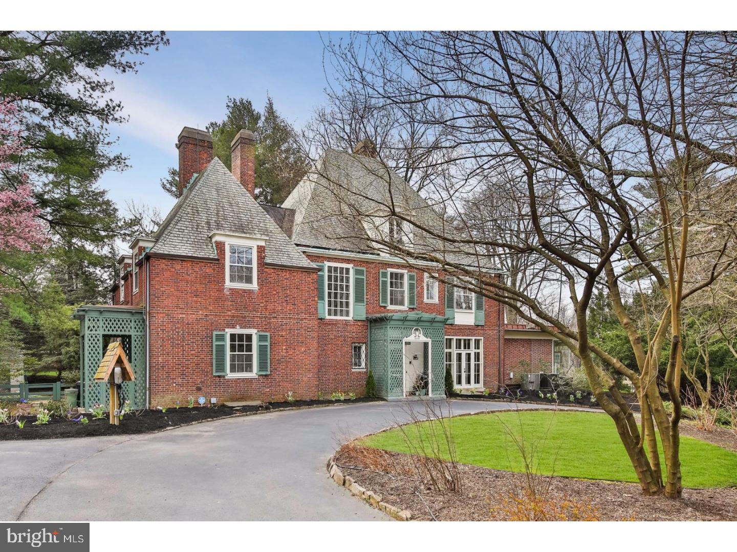 For those who appreciate timeless, traditional elegance, the Harrington House combines a classic, refined approach to living with all of the conveniences of modern life. Nestled in the Wissahickon, this stately manor home, designed by renowned local architect Edmund B. Gilchrist, has retained the beautiful original details like the slate roof and four marble wood burning fireplaces, but has been updated with more modern features such as a central air and an electric car charging station in the circular drive. The first floor begins with the foyer (and powder room) which leads to the formal living room that also provides entry to the adjacent green house. The formal dining room features a fireplace surrounded by custom built?in shelving. Two sets of French doors open to the solarium kitchen and breakfast area that are accommodating enough to create a family center appropriate for any occasion. The gourmet kosher kitchen with custom cabinetry, granite counter tops, center island, and premium stainless steel appliances. The multiple sliding doors alternately lead to the hot tub, the flagstone terrace, or the planting garden. The left wing of the first floor includes an office with a private entrance, a bonus room, and a laundry room. The staircase to the second floor continues the lattice design and leads to two large bedrooms and another full bath. The owner's suite takes center stage with a fireplace, built-ins, and double French doors opening on to a wrought iron walkway. The en suite bath features a whirlpool tub, an oversized shower with dual shower heads, an expanded sink area surrounded by custom built-ins, and a vanity area. The suite is rounded out with a walk-in closet and comfortable office/sitting area. The third floor has two additional large bedrooms and another full bath plus ample storage space. The spacious lower level features newly installed carpeting in the family area, storage space, a work area, a small powder room, and a fireproof safe. Your private backyard oasis of nearly an acre includes two waterfall ponds, one of which is shaded by a weeping hemlock tree. The spacious 2 car garage with loft area is located down a tree-lined private drive complete with a basketball court. At the end of the street you'll find yourself entering the Wissahickon trails, one of West Mount Airy's favorite destinations. You're also minutes away from all of the shops, restaurants, and places of worship that Mt. Airy and Chestnut Hill have to offer.