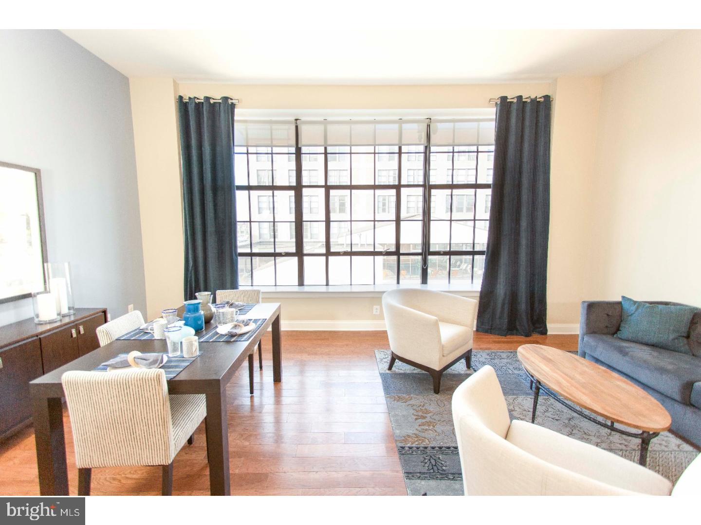 Broad Street's finest! Luxury one and two bedroom apartments in a Fabulous location! This 7th floor north facing one bedroom features an open floor plan with oak hardwood flooring, an upgraded kitchen with stainless steel GE appliances, granite counter-tops, and beautiful cabinetry, Bosch washer and dryer in each unit, wall to wall windows with custom sun shades, 2 zone energy efficient heating and cooling systems. The building features a front desk attendant and will feature a brand new Fitness Center!! Located just steps away from Marc Vetri's Alla Spina and newly opened South Kitchen and Jazz Bar! Just 2 blocks from the Broad Street subway. SUPER pet friendly!! On site parking is available at 160 dollars per month. **Photos pictured are from the model unit with a similar floor plan.
