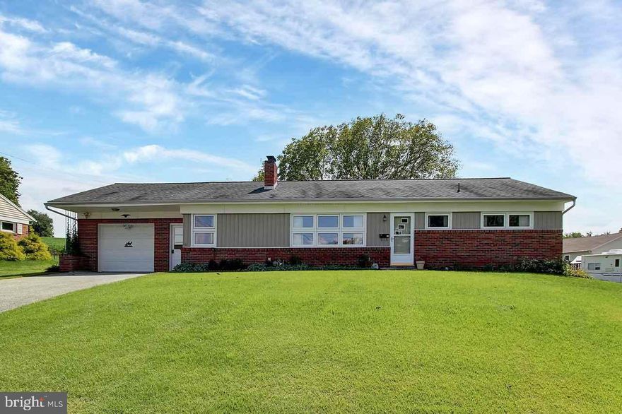Beautifully well maintained rancher sits on over a half acre w/ gorgeous views! One owner. Home boasts family room with exposed brick wall, brick working fireplace in living room, partially finished basement, oversized garage & covered patio. There are hardwood floors under the carpeting! Dallastown schools. Good for MD commuters. Appliances convey. This is an estate.  Move in ready. Make this your own & call it home!