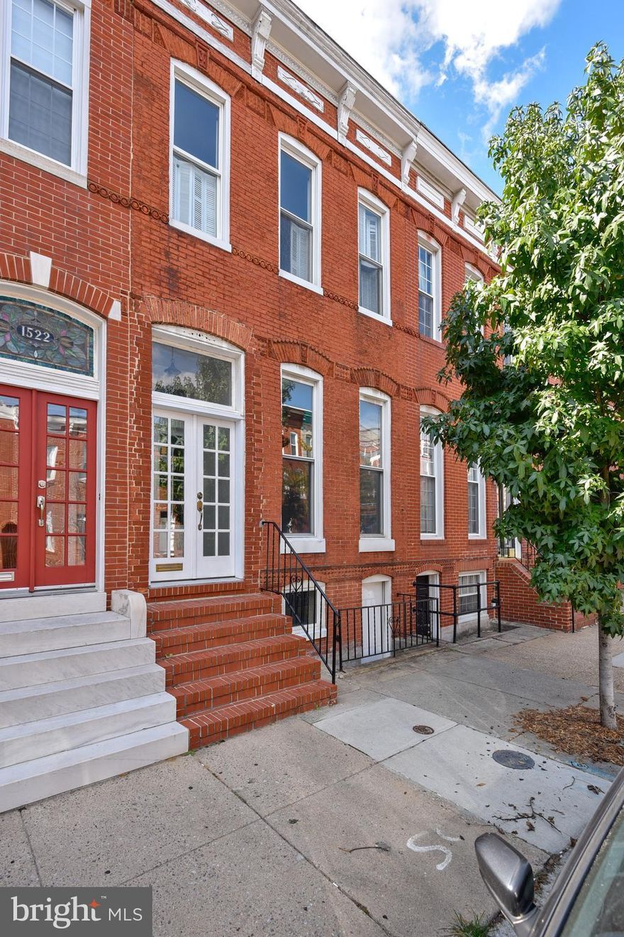 A traditional Federal Hill row home with charm throughout. Inlaid hardwood floors upstairs and down, exposed beam ceilings in kitchen, and tons of light. KIT boasts granite counters and stainless appliances, breakfast nook, custom island. Family room off of kitchen with wet bar. MSTR BR has WIC closet and en suite bath with whirlpool tub. 2 tiered roof top deck. Patio off kitchen w/gated parking.