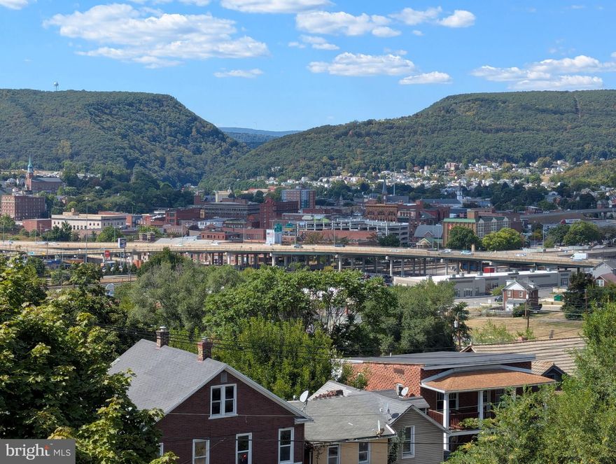 UNMATCHED VIEWS & ENDLESS POTENTIAL. Perched in a prime location with breathtaking views of the city, 346 Williams Street is ready for its next chapter. This 3-bedroom home offers a classic Cumberland layout with distinct living and dining spaces. While the home requires some renovation, the "bones" and the vista provide a foundation that is hard to find at this price point. Whether you are looking to create a modern mountain retreat or a charming city cottage, the views alone make this a project worth taking on. Sold as-is.