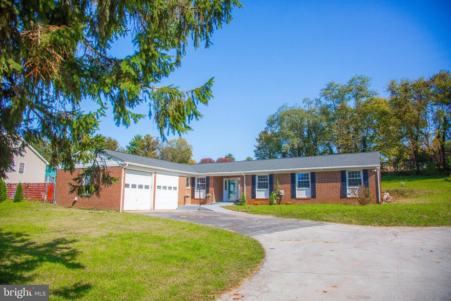 This spacious 2,104 sq. ft. brick rancher offers the perfect blend of comfort and accessibility. With 6 bedrooms and 2.5 bathrooms, it’s designed for easy living and entertaining. Freshly painted throughout with new flooring installed in the kitchen & hallways.   A beautiful brick fireplace with a woodstove is featured in the living room. The eat-in kitchen has stainless steel appliances & a large pantry.  Down the hallway, you will find 3 bedrooms, a full bathroom, and 1 of 2 possible Primary Bedrooms. This primary bedroom and the full bathroom with a walk-in shower are both fully wheelchair accessible.  On the opposite side of the home, you will find the 2nd possible Primary Bedroom  & Bedroom #6. This primary bedroom has a large walk-in closet that leads out to the sunroom.  Step outside to the 18'x36' in-ground pool, complete with a patio area perfect for summer gatherings. A Life Saver Safety fence has been professionally installed for peace of mind. (Note: the pool liner needs replacement; estimates range from $7-10k, reflected in the pricing.) The home is fully wheelchair accessible with accommodations such as a wide hallway, primary bathroom shower, and ramp walkway.  The integrated whole-house generator runs on propane, ensuring you’re prepared for any situation. (Conveyed in as-is condition, requiring hookup and maintenance.)  There is plenty of parking in the paved driveway or the one-car garage.   Nestled on a corner lot close to downtown, this home is just a short walk from a local park featuring playgrounds, sports fields, and walking/biking paths. With easy access to 340 & 9, you’re only 10 minutes from Loudoun County.  Don’t miss out on this incredible opportunity for one-level living with a pool in this prime location!