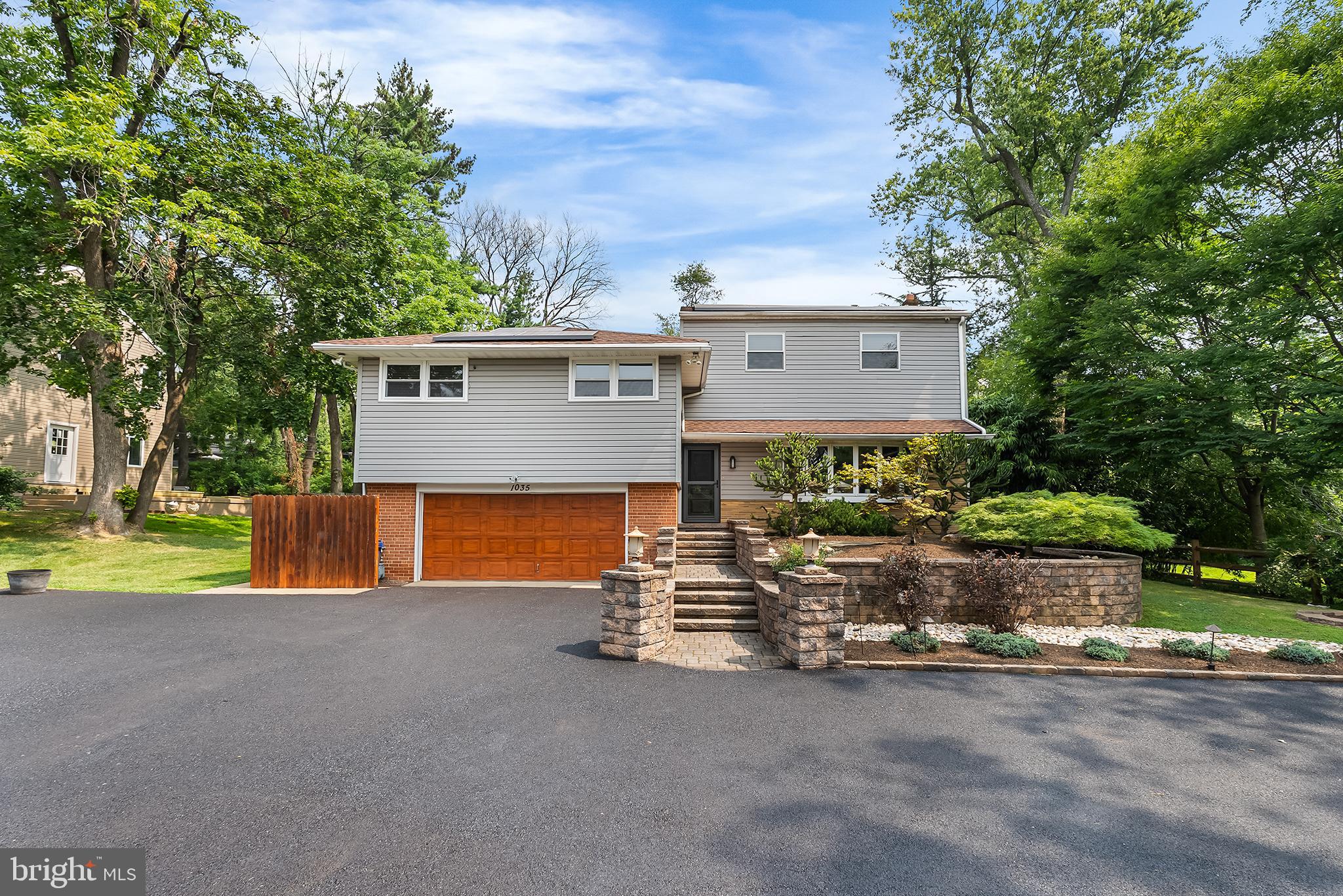 Beautiful split level located in the Crosswicks neighborhood of Abington Township. Main level foyer entrance that leads to an open floor plan. Large living and dining areas which includes front bow window and rear sliding doors off the dining room that allows for ample natural light, recessed lighting, ceiling fans, and hardwood flooring. Dining room has access to an elevated deck. Kitchen can be accessed from both living and dining rooms and has a breakfast bar, sub-zero refrigerator, stainless steel appliances, Corian countertops, recessed lighting and window allowing for additional natural lighting and overlooks rear yard and pool. Stepdown to the lower-level rec room featuring a stone fireplace with wood burning insert, sliding doors that lead to rear patio and pool. Additionally, there is a half bathroom, and access leading a two-car garage. Follow a few more steps down leading a full finished basement. The basement allows for an additional entertaining area featuring a bar and has access to a laundry room. Going a few steps up from the main level living area you will find two bedrooms. One bedroom features a remodeled full bath. The second large bedroom can be converted back to two separate bedrooms. The second remodeled bathroom is accessible from the hallway. Up a few final steps lead to the main bedroom suite. This features a large walk-in closet, a full bathroom including a walk-in shower and sauna. Exterior features of the home are a large circular driveway with an eight-car capacity, two car garage, inground pool, rear patio, rear deck and storage shed.