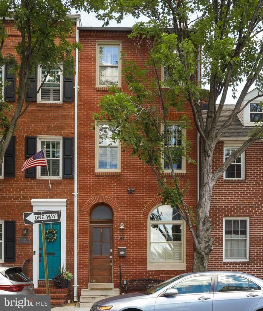 Breathtaking Federal Hill home with Parking!  This 3 bedroom home has 3.5 bathrooms, private parking, roof top deck and a finished lower level living room/home office.  Walk in to find all the character you could possibly expect in a renovated home with original wood floors, exposed brick, exposed wood ceilings and separate living & dining rooms. The spacious kitchen has 42" cabinets with plenty of storage space, granite counters, stainless appliances and walks out to the rear parking pad. The 2nd floor has 2 bedrooms, 2 full bathrooms and the laundry room. The 3rd level is where you'll find the primary bedroom with a large full bathroom plus a wet bar and sliding glass doors to a rooftop deck that leads to the upper level rooftop deck where you will have a spectacular view of the city skyline.  The finished lower level is perfect for extra living space, the home office or guest room and has an additional finished storage room.