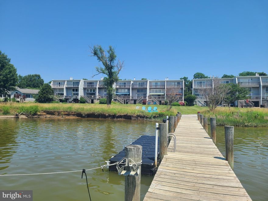Boaters paradise!    water front condo  with assigned deep water slip  on Thompson creek .  main level living room with  fire place and expansive deck with stunning  sunset views .  master bedroom  with 2 walk in closets and  deck over looking  Thompson creek.   kitchen  features hard wood floors  stainless appliances and granite counter tops
