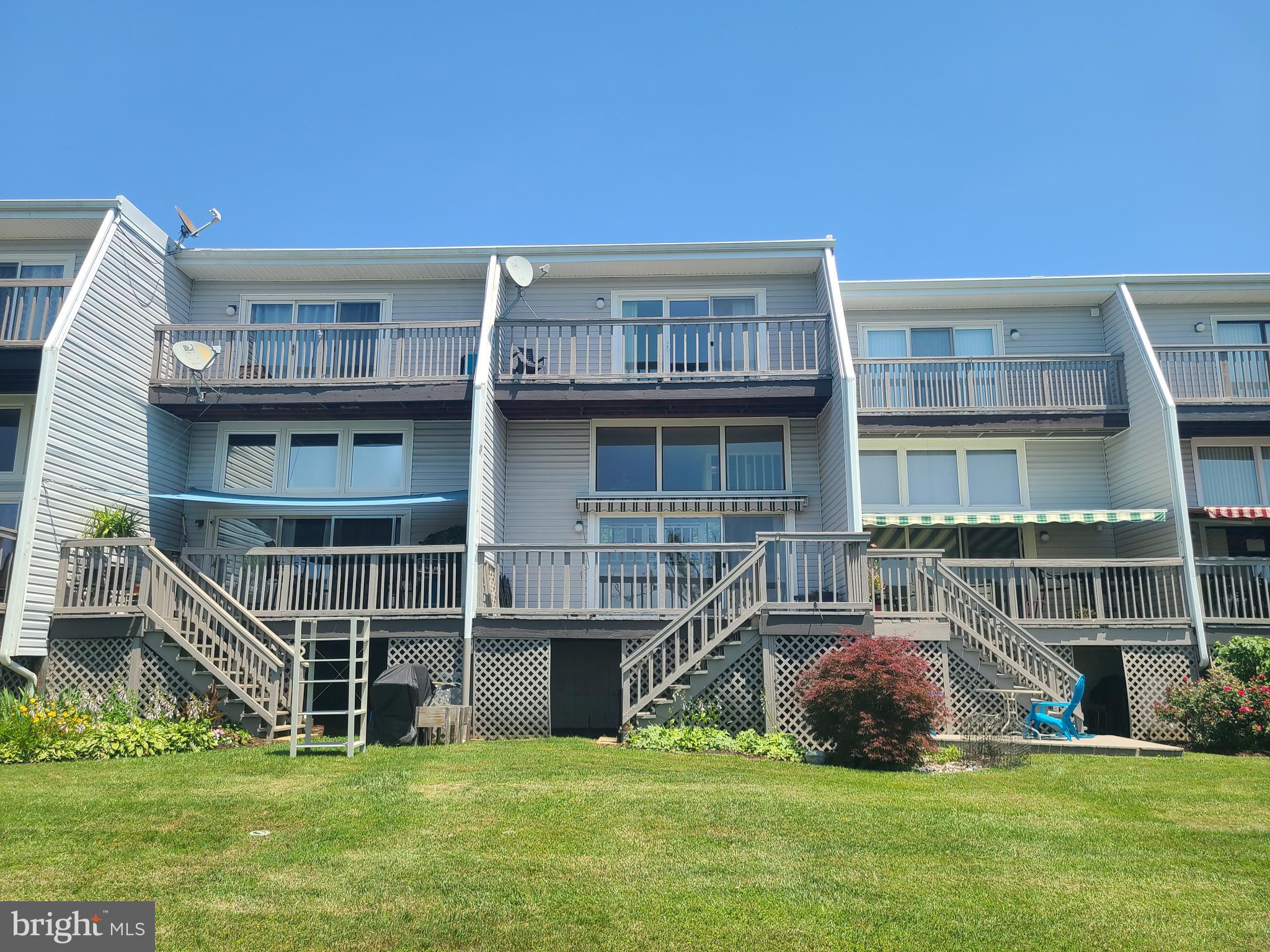 Boaters paradise! water front condo with assigned deep water slip on Thompson creek . main level living room with fire place and expansive deck with stunning sunset views . master bedroom with 2 walk in closets and deck over looking Thompson creek. kitchen features hard wood floors stainless appliances and granite counter tops