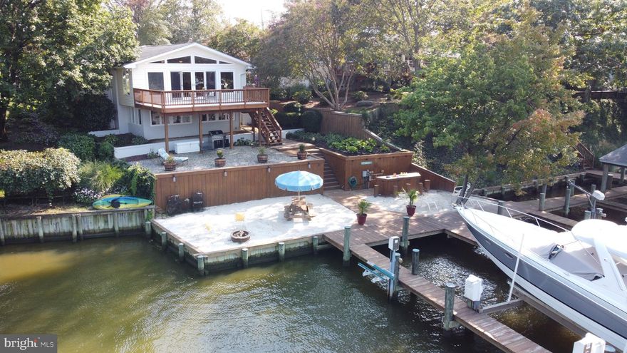 Enjoy beautiful views of Burley Creek from this turn-key 4 bedroom, 2 bath raised rancher located in Saint Margaret’s. This light-filled home features vaulted ceilings, hardwood floors throughout the main level living area, a gourmet kitchen finished with Kenmore Elite appliances & granite countertops, a wet bar w/wine fridge, gas fireplace, 3 main level bedrooms, large waterside deck, a fully screened breezeway and a large 2 car garage.  The lower level has a spacious waterside recreation room with a gas fireplace, a bedroom, full bath & a large laundry room/workshop with plenty of storage.  The waterside Tiki bar and beach pad make this home an entertainer's dream. The protected deep-water pier offers 3 slips, 1 boat lift & 2 jet ski lifts.  Close proximity to Downtown Annapolis, Rt. 50 & quick access to the Chesapeake Bay.