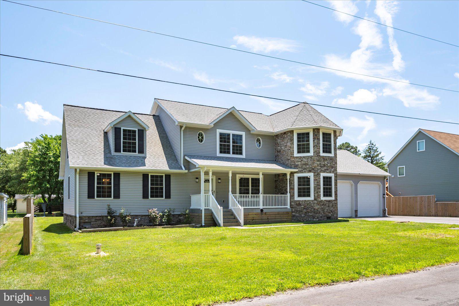 An extraordinary opportunity awaits with this remarkable canal-front home offering direct water access to Assawoman Bay via Greys Creek—your personal gateway to Ocean City by boat. With no HOA fees, oversized garage storage for boats or RVs, and a newer private dock with water, electric, and a separate like new boat lift, this home is a true gem for boaters and waterfront enthusiasts. Custom-built in 2008 and impeccably maintained, this 4-bedroom home with large bonus room over garage which could serve as a 5th sleeping area, boasts over 3600 sq ft of stylish, open-concept living space. There is updated luxury vinyl plank flooring throughout the main level and newer carpeting upstairs. Fresh paint throughout—a true blank canvas to personalize. The kitchen features recently replaced countertops, updated appliances, plus a large walk-in pantry. There are two cooking areas, including a gas cooktop and a separate range/oven. The first-floor primary suite has a remodeled en suite bath and a spacious walk-in closet. The two-story family room has a newer pellet stove and overlook from the 2nd-floor loft. Multiple flex spaces: den/office, formal dining, bonus room, and second living areas upstairs and down. Enjoy seamless indoor/outdoor living with a screened porch, freshly re-screened, leading to a low-maintenance composite deck with two propane hookups—ideal for a grill and outdoor fireplace. The attached garage features 3 automatic doors (2 front, 1 rear), 12' ceilings (room for RV, boat, or car lift), back-up heating system to support the home’s energy-efficient geothermal water furnace system. There is a newer well pump and an encapsulated crawlspace with dehumidifier. Located on a county-maintained road, no city taxes, and easy access to both Ocean City & DE Beaches. This property is ideal as a full-time residence or vacation escape. Whether you're relaxing indoors, entertaining outdoors, or setting off by boat to the beach, this home offers effortless Eastern Shore living at its finest. Assumable VA Loan. Don’t miss this rare waterfront value—schedule your private showing today!