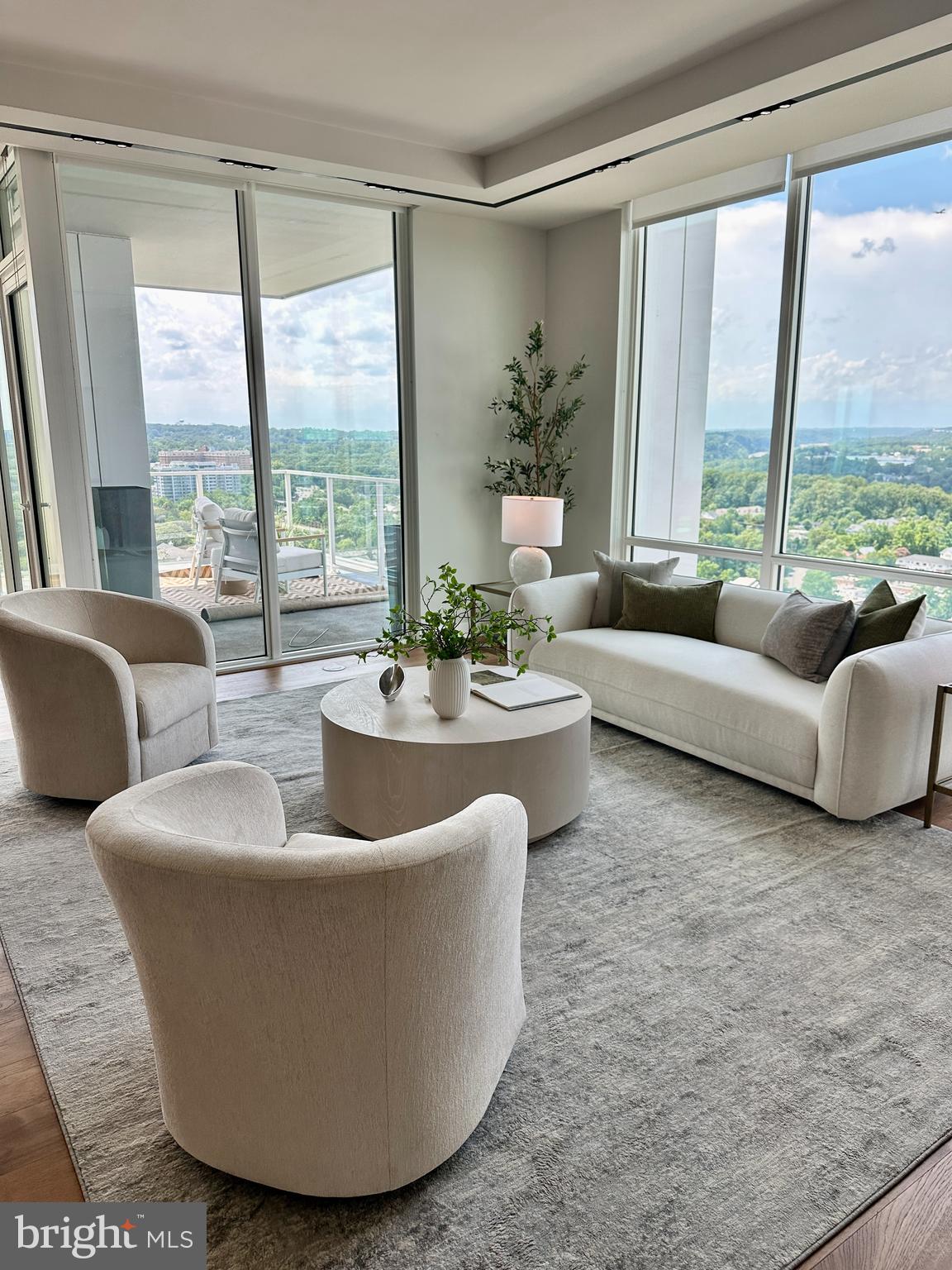$100,000 Price Improvement!
Perched above the Potomac River, this stunning 22nd-floor home at The Pierce redefines luxury living. It offers breathtaking panoramic views of the Georgetown skyline and daily sunsets, the perfect blend of city vibrancy and natural serenity.
Floor-to-ceiling windows frame mesmerizing skyline views, while a private balcony provides a serene retreat to unwind in the glow of the city lights. Designed for comfort and refinement, every detail in this home reflects top-tier craftsmanship. The chef’s kitchen is a masterpiece, featuring Thermador appliances, sleek Snaidero cabinetry, and polished quartz countertops. A spacious waterfall-edge island is a striking focal point and a perfect gathering space. Thoughtful additions—such as a 42-bottle Thermador wine refrigerator, Wi-Fi-enabled wall oven and microwave, Bosch 800 Series dishwasher, and a walk-in pantry—make this kitchen as functional as it is stunning. The expansive living and dining area is ideal for entertaining, whether hosting an intimate dinner or a lively gathering. Hand-scraped hickory floors throughout the home add warmth and timeless charm.
The owner’s suite is a true retreat, offering breathtaking skyline views. A cozy reading nook provides the perfect space to unwind at the end of the day. The spa-inspired bathroom, adorned with marble accents and heated floors, delivers ultimate comfort and relaxation. A custom-designed walk-in closet provides ample storage while maintaining an elegant aesthetic.
The second bedroom offers privacy and comfort for guests, featuring its own ensuite bath and two spacious closets. A separate laundry room with a full-size washer, dryer, and wash sink enhances convenience, while a stylish powder room is thoughtfully included for visitors.
For those who work from home or seek a quiet retreat, the expansive den provides a tranquil setting with breathtaking views of the river and skyline.
Beyond the residence, The Pierce delivers an elevated lifestyle with world-class amenities. A private elevator entrance from the lobby and parking level ensures seamless access and privacy. Residents enjoy a state-of-the-art two-story fitness center, including a full suite of fitness machines and free weights, as well as a yoga room; a resort-style 65-foot pool with an outdoor bar, lounge, and grilling area; and an elegant club room with a fireplace and bar—perfect for entertaining. In addition, a conference room is available.
The rooftop terrace offers a gourmet cooking space, stylish lounge areas, and sweeping panoramic views of the capital’s monuments, providing the ultimate urban escape. Additional conveniences include on-site bike storage, electric vehicle charging stations, a dog-washing station, and two premium reserved garage spaces, steps from the private elevator. A 24-hour concierge service ensures every need is met with exceptional care.
Located in the heart of Rosslyn, this residence provides easy access to daily conveniences, restaurants and cafés, and yoga studios. Everyday essentials, such as Safeway, CVS, and Target, are conveniently located nearby. Freedom Park, Gateway Park, Roosevelt Island, and the Mount Vernon Trail bike path along the Potomac offer nature lovers peaceful green spaces. With Ronald Reagan Washington National Airport just a short drive away, business trips or weekend getaways are incredibly convenient. A quick walk to the Rosslyn Metro (the Blue, Orange, and Silver lines) connects you seamlessly to downtown DC, and beyond, while Georgetown is accessible via a walk across the Key Bridge. Whether indulging in fine dining, enjoying world-class performances at the Kennedy Center, or exploring waterfront trails, every experience is within easy reach.
For those seeking a rare blend of luxury, convenience, and breathtaking views, this residence presents an extraordinary opportunity to call one of Arlington’s most desirable addresses home.