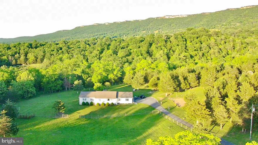 Discover serene country living in this stunning 1,920 square foot ranch style home nestled amidst the picturesque mountains of West Virginia, just a stone's throw from Seneca Rocks. Situated on 4.6 fenced acres, this property offers a perfect blend of tranquility and modern comfort.   This home boasts, 3 bedrooms, 2 baths, including a master suite, separate laundry room for added convenience, Inviting sunroom with panoramic views, gourmet kitchen equipped with 54 cabinets and oversized garage for ample storage.  This home also features Fully fenced lot with a two-acre pasture area for horses or pets,
a well-maintained asphalt driveway, poured concrete crawlspace walls ensuring durability, immaculate crawlspace, meticulously maintained and expansive yard ideal for children and outdoor activities.  
This home is tucked away for privacy, yet conveniently accessible, this home offers unparalleled peace and breathtaking long-range mountain views. Whether you seek a peaceful retreat or a place to embrace the outdoors, this property promises the best of country living.

Don't miss out on this absolute gem of a home. Schedule your private tour with us today and experience the charm and tranquility this property has to offer.