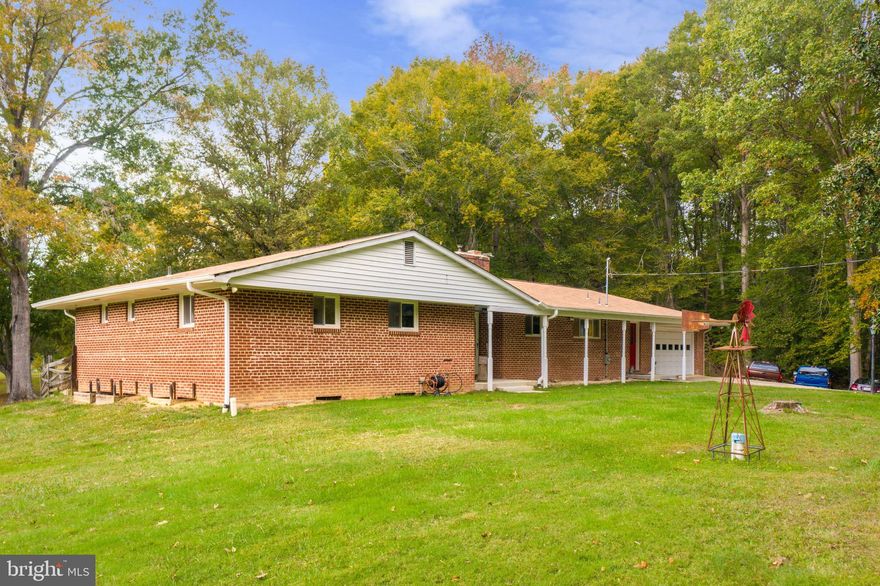 SELLER IS OFFERING UP TO $10,000.00 IN CLOSING ASSISTANCE for an accepted offer OR UP TO $11,000.00  TO BE USED FOR A 2-1 BUYDOWN with a Full Price Offer!! Serenity at it's finest awaits you at this beautiful all brick 4 bedroom 2 1/2 bath home siting on 5 lush acres. The rear deck provides amazing sunset views! The entire property is Peaceful and Welcoming. The fenced yard is perfect for your Furbaby's to play. Fabulous features include a Florida Room with Wood Insert -Big Windows and Wood Ceiling, Dining Room with carpet over tile-chair and crown moldings, Whole House Generator, 2 Hot Water Heaters, Geothermal HVAC System, 500 Gallon Propane Tank, Double Sided Gas Fireplace on Main Level, Huge Unfinished Basement with Laundry -Dry Sink -Pellet Stove and Rough In, Incredible Detached Garage complete with New Windows, Metal Roof, 3 Bays Whole House Fan, Compressed Air-perfect for Car Enthusiast and Anyone with other Projects!! This home is 5 minutes from Mallows Bay, a National Marine Sanctuary and Home of the Ghost Fleet. A perfect place to put your Boat in or your Kayaks or just take a beautiful walk.  The Calm in your life begins with this Amazing Home and Property! Don't delay, call for your private showing today and Let's Get YOU Moving!!