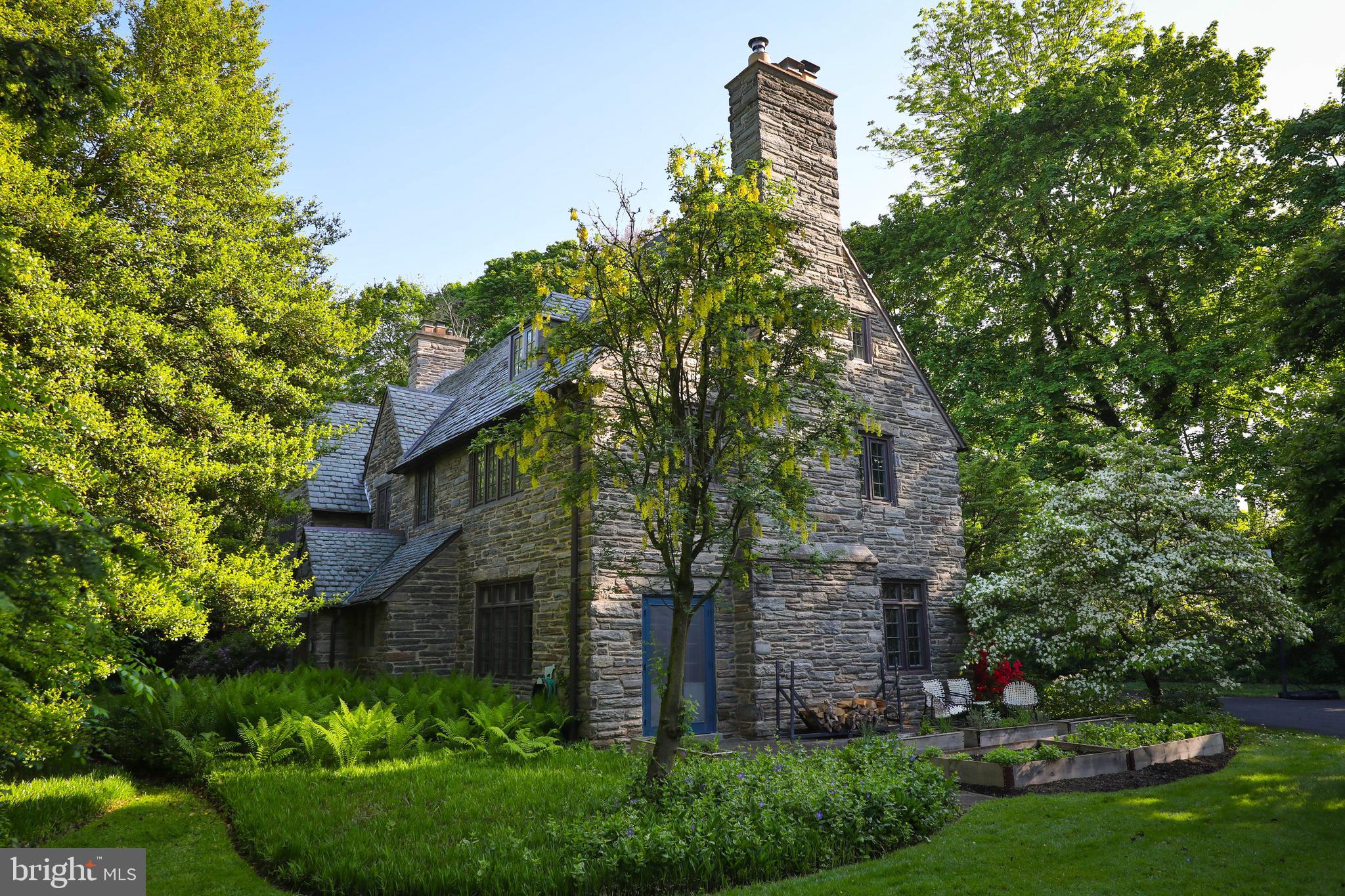 Designed in the Cotswolds style by the esteemed architectural firm Duhring, Okie, and Ziegler in 1928, this stunning 7-bedroom, 4 1/2-bath property on one of the most iconic residential streets in Chestnut Hill is an entertainer's dream! Perfect for hosting family and friends, the first floor features an updated, spacious eat-in kitchen with a wet bar and cozy sitting room. A large mud room with laundry and plenty of storage adjoins the kitchen. French doors lead from the kitchen into the dining room, which is surrounded by windows and anchored by a large wood-burning fireplace that creates a warm atmosphere for winter nights. A grand foyer with arched doorways to the kitchen and living room, a powder room, and a cozy office/ den with built-in bookshelves and a private entrance occupy the middle portion of the first floor. With windows on three sides, built-in shelving, and a stone fireplace with an intricately carved mantel, the large living room is ideal for hosting gatherings, and there's plenty of space for rolling up the rug and dancing.
Off the landing to the second floor, a recently remodeled space could serve as second-floor family room or large bedroom with its own full bath. The second floor features two spacious bedrooms with a Jack and Jill bathroom between them, a third sunny bedroom that the current owners use as a exercise room, and a large primary bedroom featuring an updated en suite full bath and a working fireplace for an extra touch of luxury.
The third floor offers versatile living options, either as an in-law suite, home office, or additional bedrooms for guests and also features a large cedar closet and plenty of storage spaces.
Outside, the beautifully landscaped yard boasts a well-tended perennial garden; fully fenced back yard; two slate patios accessed by French doors from the living room, dining room, and kitchen; an in-ground pool with flagstone hardscaping; and an outdoor shower—ideal for entertaining or relaxation in this urban oasis.
Located in a private setting with no neighbors on either side, this home is an easy walk to Chestnut Hill's shops, the Philadelphia Cricket Club, schools, Pastorious Park, and the trails of the Wissahickon Valley. Steps away from the Highland SEPTA Regional Rail station and only a 90-minute commute to New York City, it's truly a rare opportunity to own your private retreat in the city.