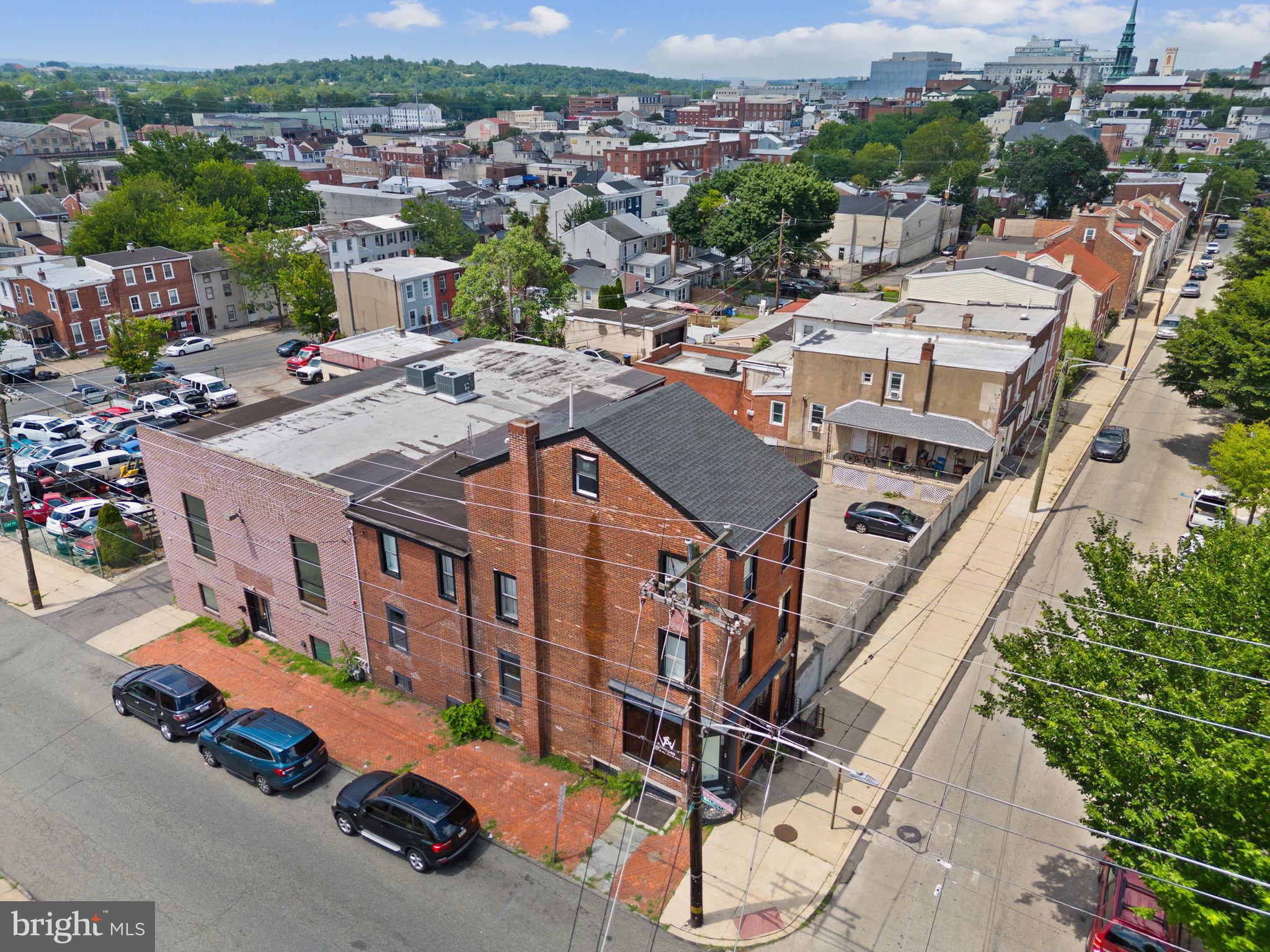 366–368 E. Moore Street, Norristown, PA, is a premier Class B mixed-use property spanning 10,970 sq. ft. across two parcels, ideal for business owners seeking to relocate their operations while generating substantial rental income in Norristown’s thriving redevelopment hub. This well-maintained property includes a 1,408 sq. ft. single-family home (4 bedrooms, 1 bath) with hardwood floors, a new kitchen with granite countertops and stainless appliances, plus a 9,562 sq. ft. commercial building featuring a modern 1,235 sq. ft. apartment (2 bedrooms, 2 bath) with hardwood floors, a new kitchen, and in-unit washer/dryer. The commercial building offers a 4,215 sq. ft. upper commercial space with lofty ceilings, large windows, a glass-walled conference room, and multiple offices, and a 4,112 sq. ft. lower commercial space with a private entry, showroom, large garage bay/workspace, and break room. Business owners can occupy one or both commercial spaces while leasing the residential units or unused commercial space for added revenue. Upgrades include a 5-year-old roof, multi-zoned HVAC with AC, and gated parking for 12+ vehicles. Zoned R-2 Residential with grandfathered commercial uses (e.g., prior gym, contractor offices), buyers must verify uses with Norristown Borough. Located near the Montgomery County Courthouse ($48M renovation, completion 2026), Schuylkill River Trail, and Elmwood Park Zoo, this property is a prime investment. Contact us to explore!