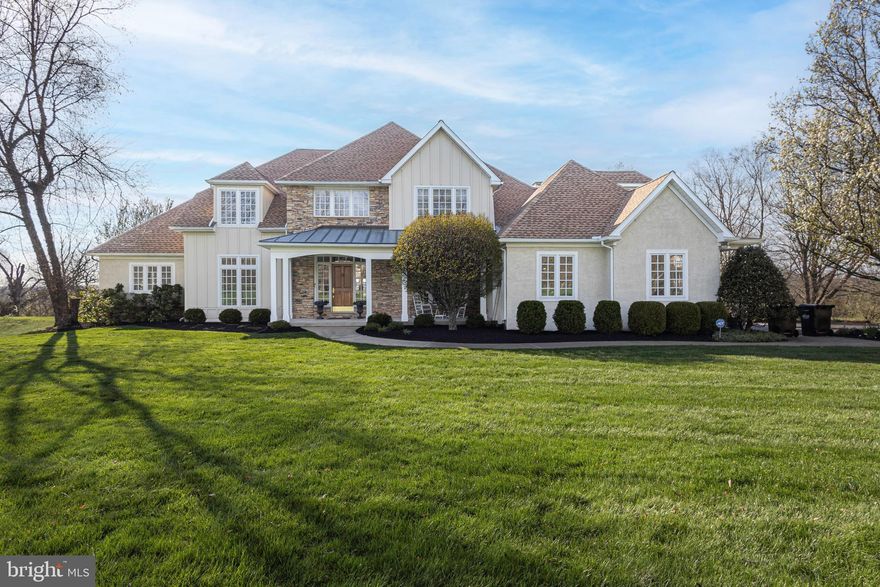 Gracefully set within the intimate and prestigious enclave of Tamarack Farm in Solebury Township, this custom residence sits on nearly two private acres.  The property is located at the end of a quiet cul-de-sac, backs to preserved land and offers sweeping, long-distance views.  Exceptional craftsmanship is evident at every turn, with extensive millwork, wainscoting, crown molding, custom cabinetry, and rich hardwood floors.  With over 5,600 square feet of living space, the home offers five bedrooms and five-and-a-half baths, including a highly desirable first-floor primary suite. Featuring an open-concept design, the home showcases a dramatic two-story foyer and living room, where walls of windows bathe the interior in natural light throughout the day.  The living room is anchored by one of three fireplaces, which flows seamlessly into the great room, where a striking stacked stone fireplace is flanked by custom built-ins. The gourmet eat-in kitchen is designed for both everyday living and entertaining and features custom cabinetry, high-end stainless steel appliances and an expansive center island with counter seating.  A half bath and generous sized laundry room inclusive of a dog bathing area completes the first floor and connects to the 3-car attached garage.  Upstairs, there are three additional bedrooms, two full baths, a versatile bonus room, and a walk-up attic providing ample storage.  The fully finished walk-out lower level includes a sun-filled fifth bedroom and full bath, ideal for an in-law or au pair suite. This level also features a spacious home theater, a Mercer tile fireplace, a wet bar with wine refrigerator, and custom built-ins with soapstone countertops.  In addition, there is an exercise room and additional flex space perfect to be used as an office, crafts, or game room.  Outside, a series of wraparound porches and a covered pergola l invite you to entertain or just relax and take in the serene surroundings. This property offers privacy and a one- of- a- kind setting within the award-winning New Hope¬ Solebury school district. An extraordinary opportunity to own a residence in one of the region's most sought-after locales. Schedule your private tour today!