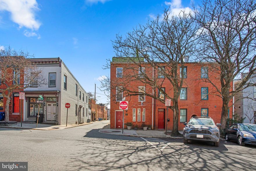 Absolutely gorgeous 3 bedroom 2.5 bath EOG townhouse with oversized garage parking in the charming historic Upper Fells Point neighborhood. Beautiful hardwood flooring on all 3 levels and exposed brick walls scattered throughout the second and third story levels. Living room, dining room, kitchen, half bath and utility/storage room with stacked washer/dryer on main level. Spectacular kitchen has stainless steel appliances, gas stove, granite countertops and breakfast bar. Both of the two bedrooms on the second level have fireplaces with brick surround plus a full bath off hallway. Primary bedroom suite on third level has a spacious closet and a relaxing spa-like bathroom. Third level provides access to a rooftop deck with amazing views of the city. Close to shopping, entertainment, restaurants and Patterson Park. This sophisticated beauty won't last long. Must See!!!