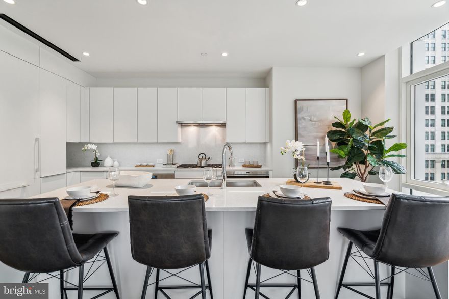 Arthaus, a commanding new residential high-rise in Philadelphia’s performing arts district, presents Unit 2102:  A stunning 2-bed, 2-bath, 1,598 SF single-level residence with City Hall and skyline views priced at $1,410,000.  

This maintenance-free, move-in ready, home offers high-end interior design, resort amenities and white gloves services. Tax abatement is available. Whether you’re a busy professional, retiree or globe trotter, 2102 is a MUST SEE!

Arthaus impresses from the moment you enter.  The tall solid wood door with elegant hardware sets the stage, leading to a spacious, light-filled foyer with the large walk in coat closet and convenient hallway bath and laundry facilities.  The great room offers panoramic views of the city featuring a blended kitchen, living and dining space with soaring ceilings, floor to ceiling windows, wide-plank Havwood flooring and a weather-protected walk out balcony. Drenched in natural light this space is bright, airy, and feels twice its size on paper.

The chef’s kitchen is everything you need for hosting, with a large center island that seats four.  The upper and lower cabinets are polar white matte by Poggenpohl and the countertops Super white quartz with matching backsplash. The high-end, stainless appliance package includes: Wolf, Bosch, Sub-Zero and Asko appliances and door fronts have been fully integrated into the cabinet design for a seamless look.

The primary suite and guest bedroom are on the east side of the condominium.   
The guest bedroom is a quiet retreat for visiting guests with gorgeous mid-town views and walk-in closet. The full bath in the hallway is finished with porcelain Calacatta tile floors, super white quartz countertops, and polar white matte Poggenpohl cabinets. The spacious Owner’s suite is wrapped in 10' floor-to-ceiling windows and features an oversized walk-in closet. A Badeloft soak-in tub, double vanity with Robern mirrors and super white quartz marble, Contempo white marble floors and shower tile, and a Kohler toilet closet complete the best-in-class bathroom package. 

Arthaus is a modern masterpiece crafted by renowned developer Carl Dranoff, designed by Kohn Pedersen Fox and built by Intech Construction.  Its architecture and amenities prioritize wellness and well-being, from the stunning Monet-inspired mosaic in the lobby to the private resort on the 6th and 7th floors, featuring a pool, fitness facilities, spa, salon, pet park, outdoor terraces, lawns, gardens and more.  White glove services include 24-doorman, concierge, chauffeured town car and car valet. 

This home comes with 1 parking license. With the tax abatement annual real estate taxes are approximately $2,745