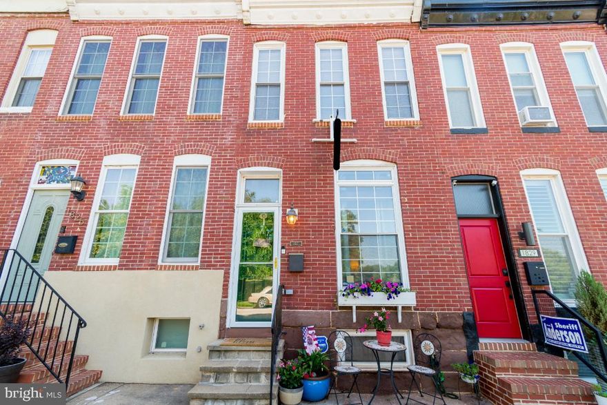 The location of 1827 Covington St perfectly blends the conveniences of city life, a quiet street with plenty of parking (non-permit) and  beautiful Riverside Park directly across the street.  This traditional South Baltimore Rowhome has many features that bring it into the modern age, all while keeping that historic charm. On the main level you will find a large light filled living room, an updated kitchen with granite counters, SS appliances and a half bath. Custom iron railings on the stair case lead to an upstairs with two bedrooms along with two full bathrooms. The iron railings continue  up one more floor to a 3rd story doghouse with wetbar that leads out a two tier rooftop deck with panoramic views of  Domino Sugar, Riverside Park, the water & the cityscape.  In the finished basement you will find laundry and another space for a den, home office or workout room. The rear patio includes a parking pad and a fenced in area that is perfect for dogs or children. The street is very quiet and no thru traffic will makes it way back to this corner of the neighborhood. Exposed brick and hardwood floors throughout this home. This one truly has it all.