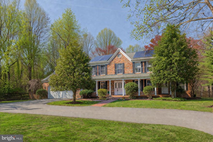 **GORGEOUSLY OFFERED & DECEIVINGLY LARGE HOME IN IDYLLIC SETTING** Nestled on 2.47 lovely, landscaped acres, this well-maintained home features a wraparound front porch that leads into a beautifully remodeled interior where light-filled, oversized rooms provide plenty of space for both socializing and quiet retreats. At the heart of the home, an oversized, chef’s eat-in kitchen - complete with stainless appliances and breakfast bar - serves as a natural hub for daily life. The main level also offers a flexible side room with its own entrance, an ideal spot for a home office or in-law suite. Follow the curved staircase to the upper level, where the primary bedroom serves as a peaceful getaway featuring vaulted ceilings, bright skylight, separate sitting room, en suite bath with double vanity, laundry closet, and balcony overlooking the deep, level backyard. Three additional bedrooms and a full bath complete this floor, while the finished lower level adds even more versatility with a large recreation room, 1-2 more bedrooms, full bath and storage. Outside, the lush, treed views from every window highlight the quiet setting, offering plenty of room to roam, garden, or even add a pool. With energy-saving Tesla solar panels and the warmth of natural gas heating, this is a well-appointed home designed for year-round comfort. Just minutes to restaurants, grocery stores, and shopping!