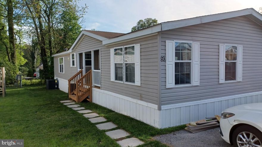 Welcome to this spacious, manufactured ranch-style home located in Odenton conveniently located to the Marc Train and Piney Orchard. This spacious residence offers three bedrooms and two full bathrooms, providing plenty of room to relax and entertain. The oversized kitchen features lots of cabinets for storage and an island for additional counter space.   Enjoy the comfort of central air conditioning and a recently updated HVAC (2023), ensuring year-round comfort. The home features and an open floor plan that enhances the flow between the living, dining, and kitchen areas. The primary bedroom is located at the front of the property while the two additional bedrooms are tucked away at the rear of the home.  The laundry room has access to the small rear deck for accessibility to rear yard space.  The covered front deck is a great place to escape from the rain. Conveniently located near local amenities, parks, and major commuter routes, this home offers both comfort and convenience. Buyer(s) must be approved by Arundel Mobile Village in order to purchase a home in this community.  Community has pet size/type restrictions.  Ask the community for additional information.  Buyers are encouraged to seek community approval prior to making an offer.