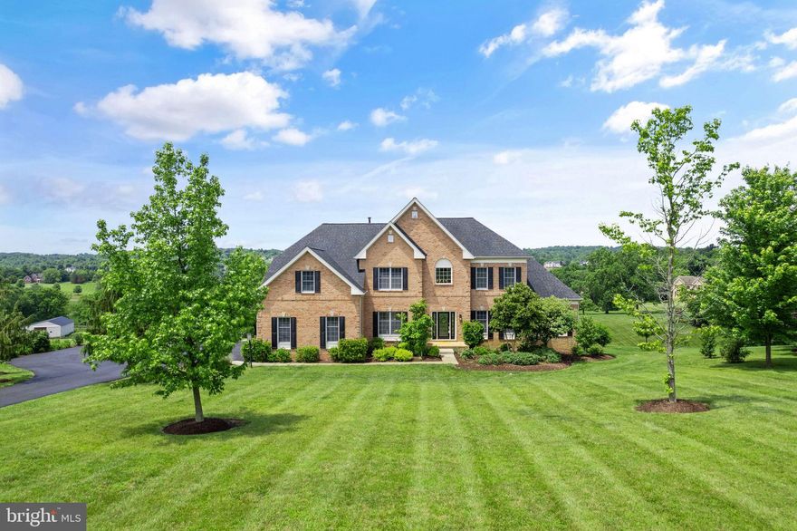 MOST BEAUTIFUL SUNSET VIEWS! Welcome home to this stunning Toll Brothers Monroe model, set on a breathtaking 3+ acre lot with panoramic views for miles! Ideally located in the sought-after Shenstone neighborhood, this home offers incredible rolling hill vistas and is just a few minutes' drive to the vibrant Leesburg historic district, the Toll Road, and all of Leesburg's best shopping and restaurants. Greet friends and family to this inviting home with its three-sided brick construction, handsome front elevation, and brand-new roof. The welcoming two-story foyer features a double-turned staircase and an elegant marble floor entry. The home offers a separate living room and dining room with a tray ceiling perfect for family gatherings as well as a main level office with built-in bookcases. The family room is the heart of the house, boasting vaulted ceilings and a floor-to-ceiling stone gas fireplace. The kitchen features upgraded Yorktown Maple cabinetry with elegant side paneling, granite counters, and stainless steel appliances. The kitchen opens to an inviting breakfast room and a charming greenhouse sunroom with skylights. Relax with a good book in the side conservatory with casement windows and dramatic tall ceilings, the perfect place to enjoy the tranquil setting. A private staircase from the kitchen provides easy access to the second-floor bedrooms. The upper level offers four spacious bedrooms, including an incredibly spacious owner's suite with a large sitting room, tray ceilings, a generous walk-in closet, and a private bath featuring separate vanities, a soaking tub, and a separate shower. The secondary bedrooms are equally spacious, with one offering an en-suite bath and two additional bedrooms sharing a bath. The walk-out lower level is filled with natural light, features 9' ceilings, and is ready for your finishing touches. Step outside to enjoy the expansive low-maintenance deck and gazebo, perfect for sipping a cup of coffee or a glass of wine while taking in the best views in Loudoun County. The property also includes ample space for any of your future outdoor projects and a serene pond at the edge of the lot. Enjoy a barbecue and summer gatherings in this beautiful home which is move-in ready with tasteful paint decor, hardwood flooring, and new carpeting and lighting fixtures, and nestled on a perfect lot that offers complete beauty and tranquility. This home is more than just a place to live— it's your forever home! Seller Prefers Community Title.