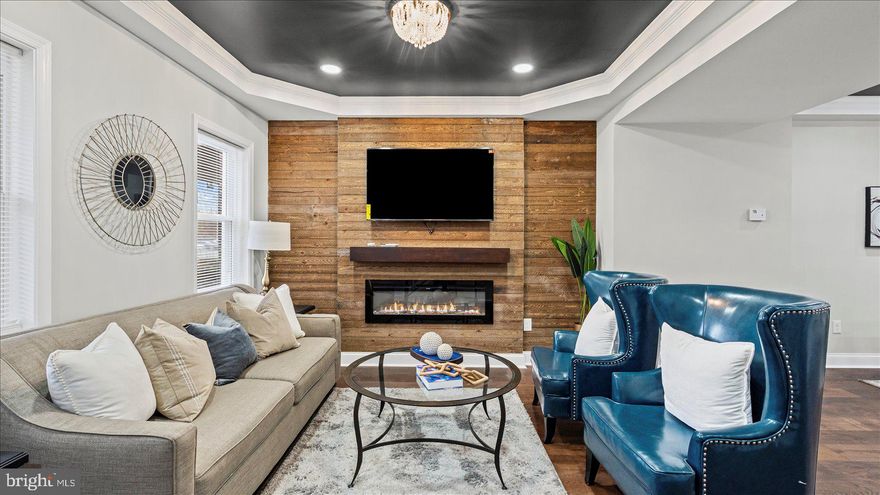 Beautifully transformed 4BR/2BA Townhome located on a quiet street in Central Park Heights.  Make your way to the covered front porch and open the door into your elegantly upgraded new home. The main floor is stunning featuring custom coffered ceilings boldly painted giving depth to the room, beautiful wide plank wood style flooring, recessed lighting, a soft color palette, elegant lighting fixtures, and the open floor plan homeowners are seeking.  The main floor boasts a large living room with a custom wood plank feature wall hosting an electric fireplace and wood mantel, a spacious dining room, and gorgeous kitchen.  The kitchen features plenty of cabinets, granite countertops with a subway tiled backsplash, stainless steel appliances including an electric slide-in range, and an island with a stainless sink, pendant lights, and breakfast seating.  On the newly carpeted second floor are two sizable secondary bedrooms, a larger primary bedroom, and a new full bath with tile from ceiling to tub.  The lower level offers additional living space featuring the fourth bedroom, a full bath with walk-in shower, a family room, laundry, storage, and a walk-out to the fenced yard.  From the kitchen step outside to a covered, newly constructed, deck that overlooks green space and offers so many possibilities.  This home is move-in ready with so much to offer new homeowners, and is nearby shopping, restaurants, and commuter routes.