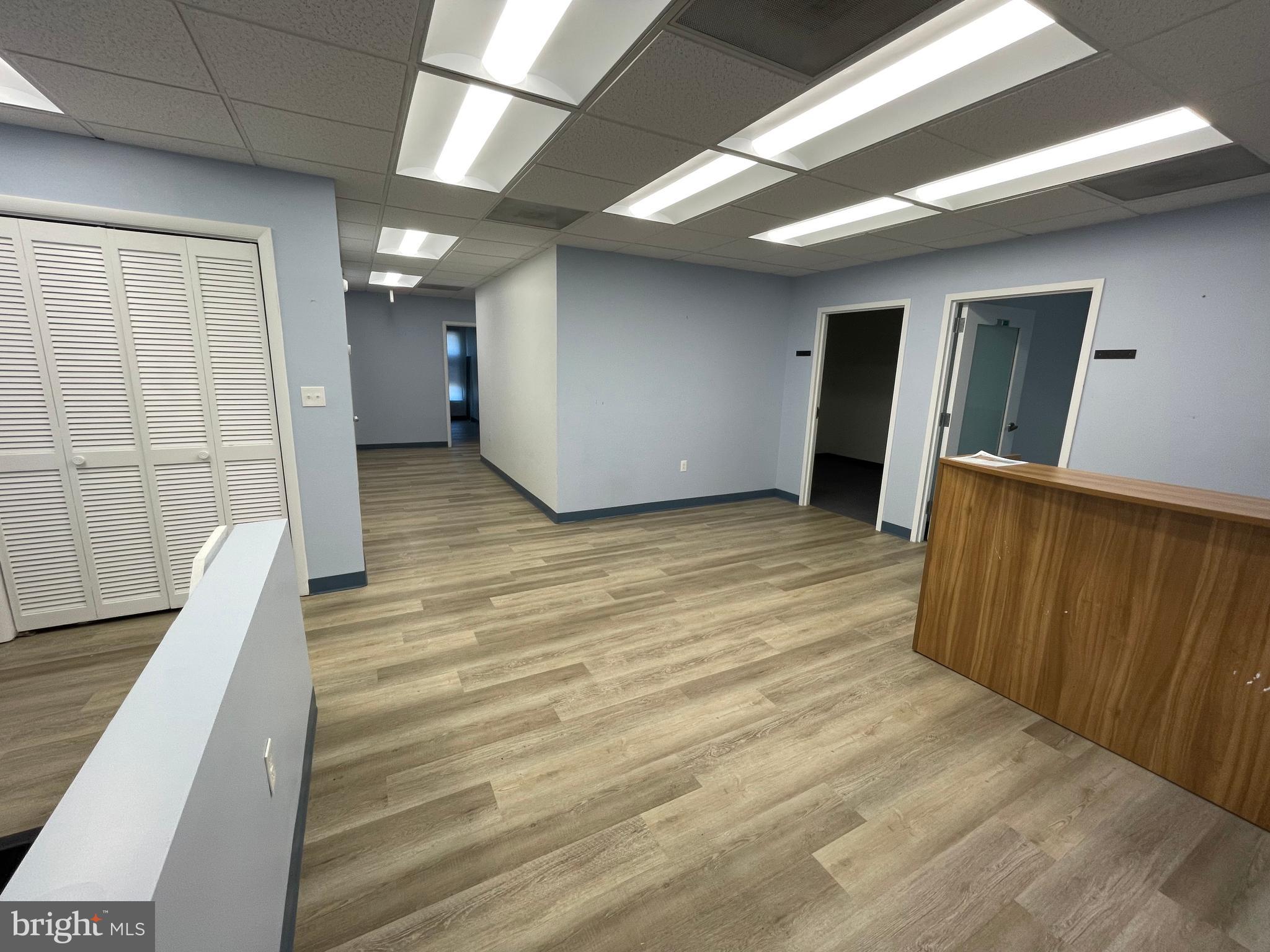 Well-Configured Office Suite with Natural Light and Functional Layout
This suite features six private offices, offering ample space for focused work or individual team members. A welcoming reception area with a built-in desk creates a polished entry point for visitors and clients.
The space includes a breakroom for added convenience, though it is not equipped with a kitchenette. Durable luxury vinyl plank (LVP) flooring runs throughout the common areas, providing a modern, low-maintenance finish, while private offices are carpeted for comfort.
Operable windows allow for fresh air and natural ventilation, enhancing the overall work environment.
Prime Location with Exceptional Accessibility
Ideally situated within walking distance of the vibrant Rockville Courthouse district, this office space offers convenient access to a wide range of services and amenities. Tenants and their clients will appreciate ample on-site parking, ensuring hassle-free arrivals and departures.
Just 0.2 miles from Rockville Metro and 0.3 miles from Rockville Town Center, the location provides seamless connectivity and access to shopping, dining, and entertainment options. Positioned just off Route 355, this space combines visibility with easy commuter access, making it an ideal choice for growing businesses.
