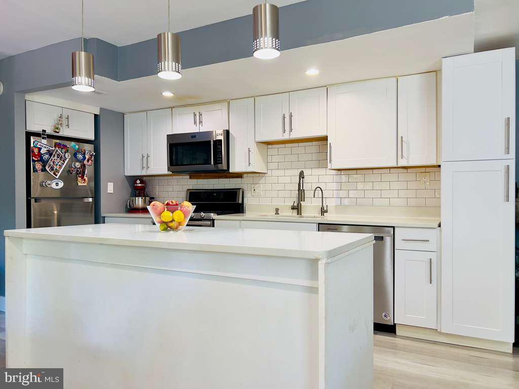 Assumable FHA loan at 3.125% with a balance of around $192,000. Only assumable by a person who will live in the unit.
Discover this stunning, fully updated 2-bedroom condo in the highly desirable Bethesda Park community. This home has undergone a comprehensive floor-to-ceiling renovation that happened in 2020 for the open floor plan and 2022 for the bathroom that doubled in size with the condo fee covering all utilities and 2 parking spaces for your convenience. The bright and open floor plan is accentuated by recessed lighting and showcases one of the largest bathrooms in the community. The gourmet kitchen is sure to impress, featuring stainless steel appliances, premium quartz countertops, a spacious island, contemporary white cabinetry, a designer backsplash, and custom pendant lighting. Abundant natural light streams through the sliding glass doors, leading to your private patio. Perfectly situated, this condo is close to both White Flint and Twinbrook Metro stations and just minutes away from shopping, dining, and entertainment options. Enjoy community amenities such as a pool, tennis courts, and tot-lots, with easy access to I-270 and I-495. Don't miss out on this exceptional opportunity—Unit #1, Legal Unit #425 is a must-see!