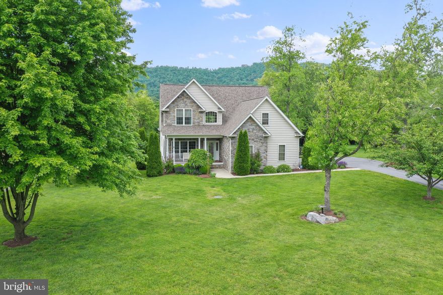 Spectacular custom-built home in quiet country setting.  Soaring 2-story ceiling graces the family room and large windows that highlight the amazing views and let in tons of natural lighting. Hardwoods throughout the main level and lovely architectural details include stone fireplace with wood mantel and Palladian window in the primary suite. The kitchen is a delight with granite counter tops, upgraded cabinetry, and stainless-steel appliances.  The primary suite is conveniently located on the main level in the rear of the home to take in the amazing views.  This peaceful retreat is complete with private bath including separate jetted soaking tub and custom tile shower, upgraded vanity with double sinks.  Upper level has a loft and three additional bedrooms plus full bath. The property is on a level lot with ample parking.  The rear of the property is fenced and includes a patio that walks up to the covered deck, also accessed by the family room, and a screen porch accessed by the breakfast area.  There is laundry on the main level and a full unfinished basement.